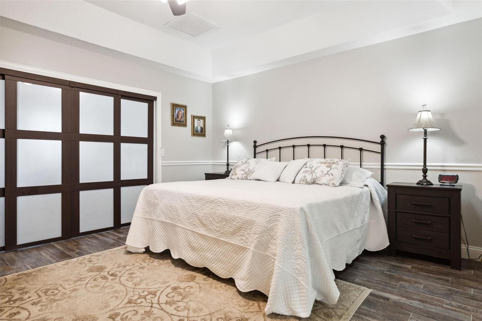 Beautiful master bedroom with cali-sliders into the expansive his and hers master closet.