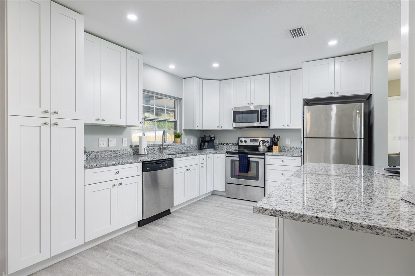 Modern Kitchen with shaker cabinets, granite counter tops, and stainless steel appliances