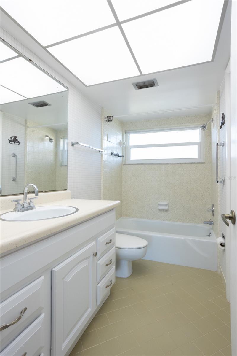 Spacious bathroom with additional door for guest