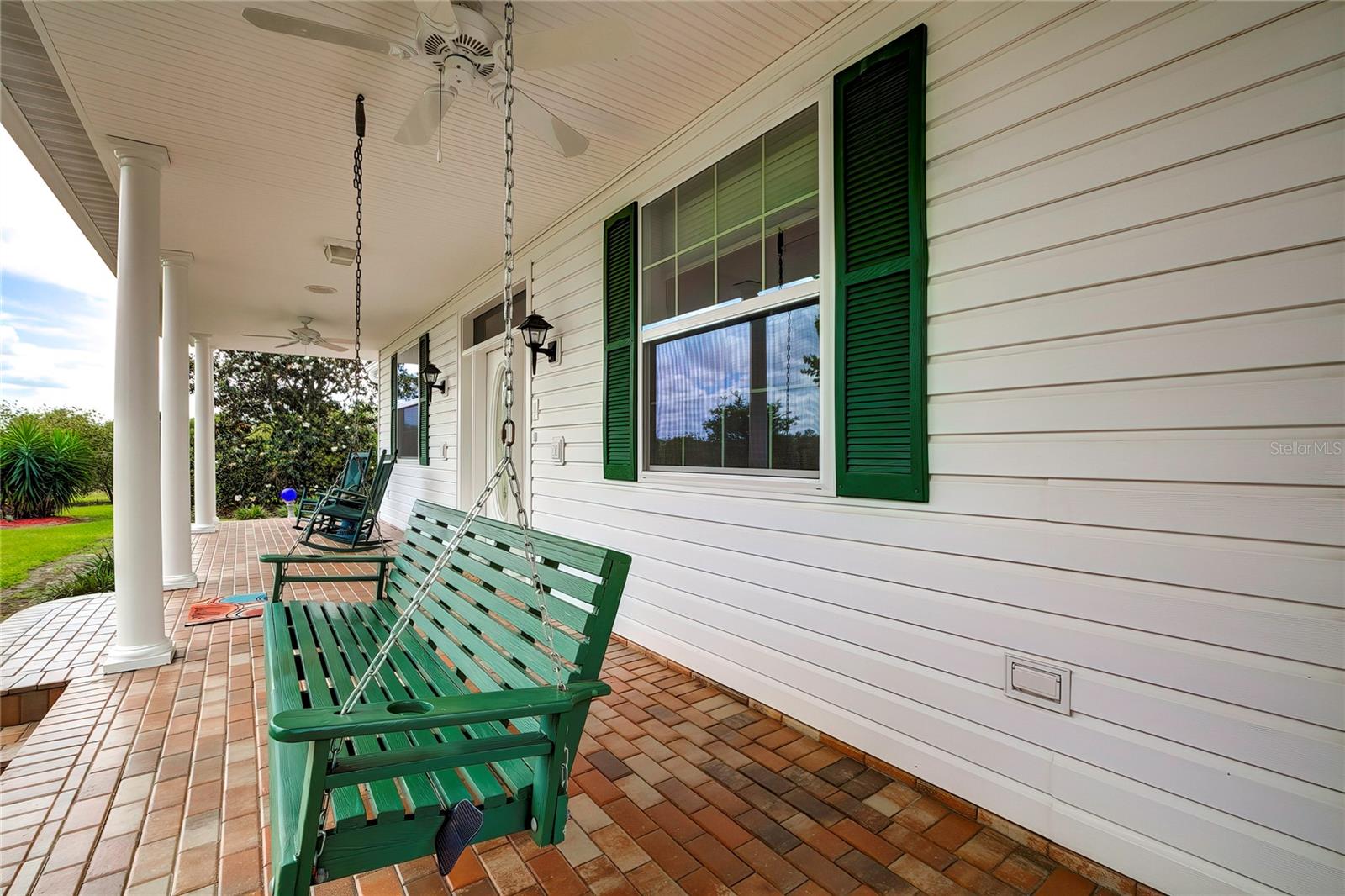 Rocking Chair Front Porch Adorned with Brick Pavers