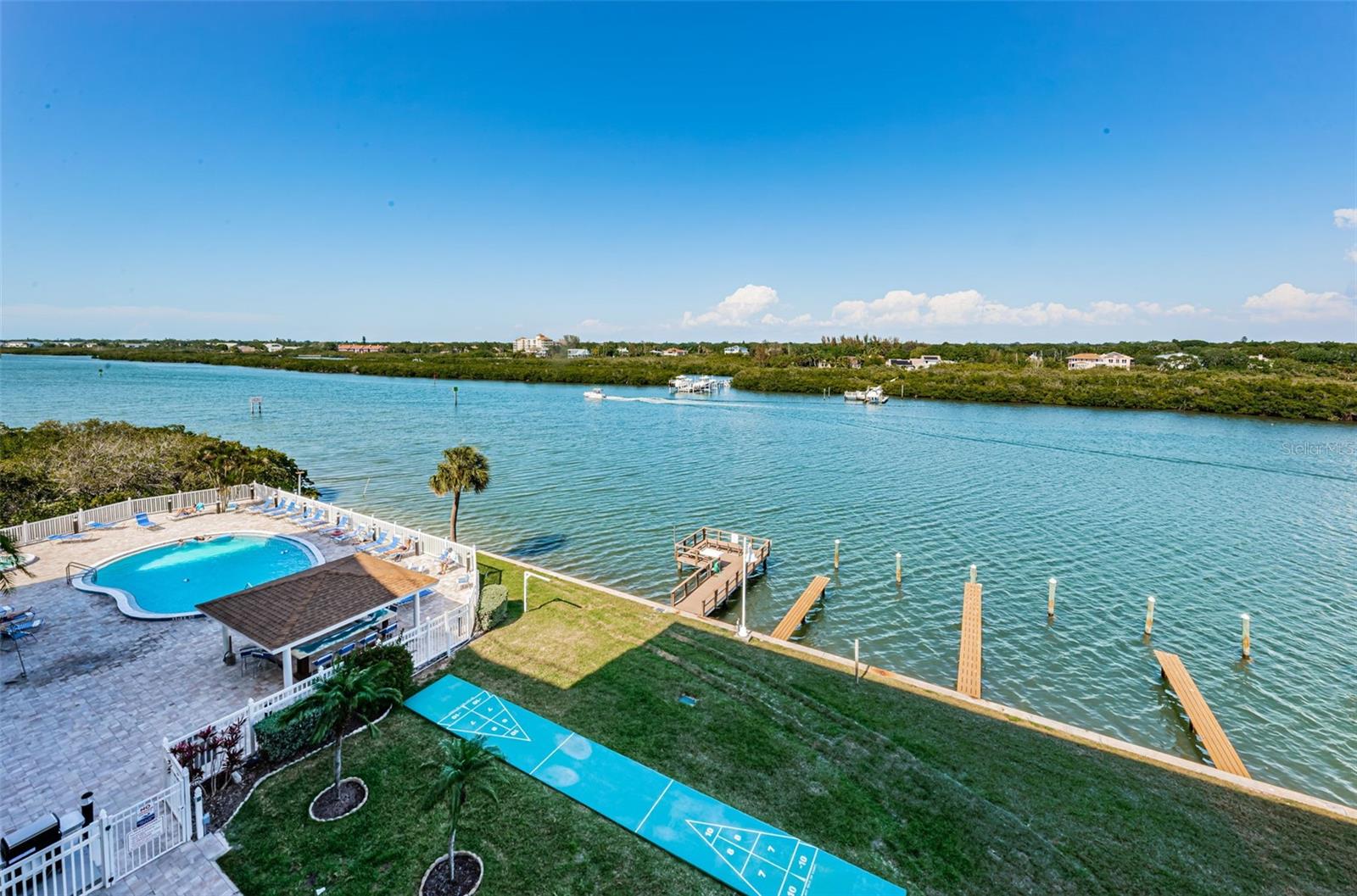 The balcony overlooks the pool and patio area as well as the Boat Docks!