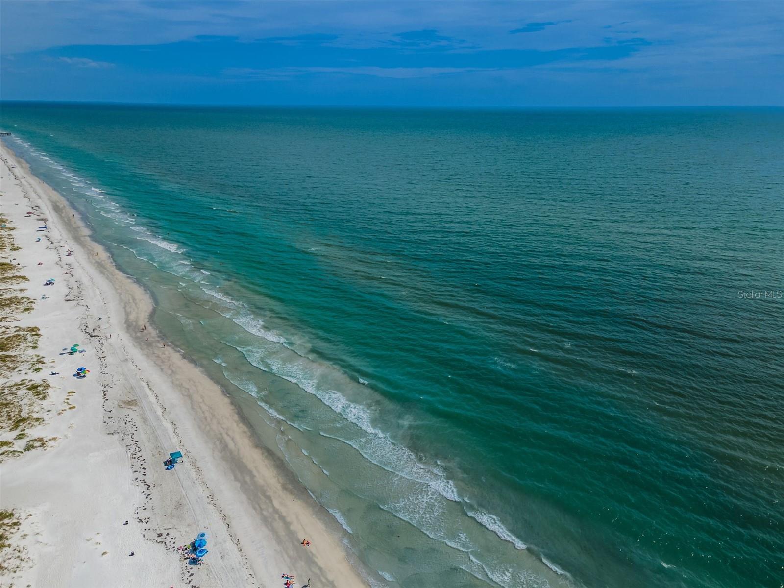 The sandy beaches of the Gulf of Mexico across the street