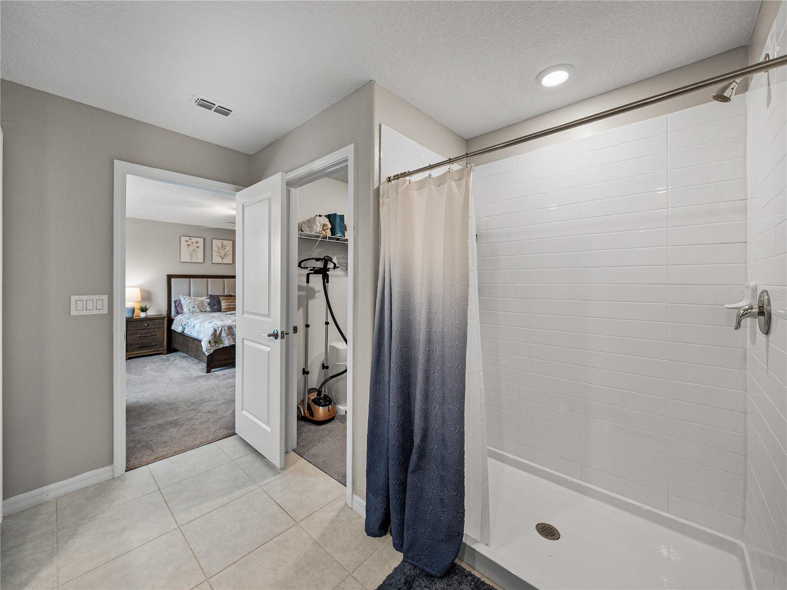 Master Bath with dual sinks, separate toilet room, linen closet and walk in shower.