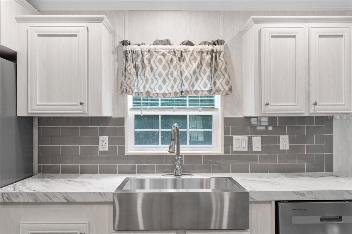 Kitchen w/Farmhouse Sink and window to Backyard