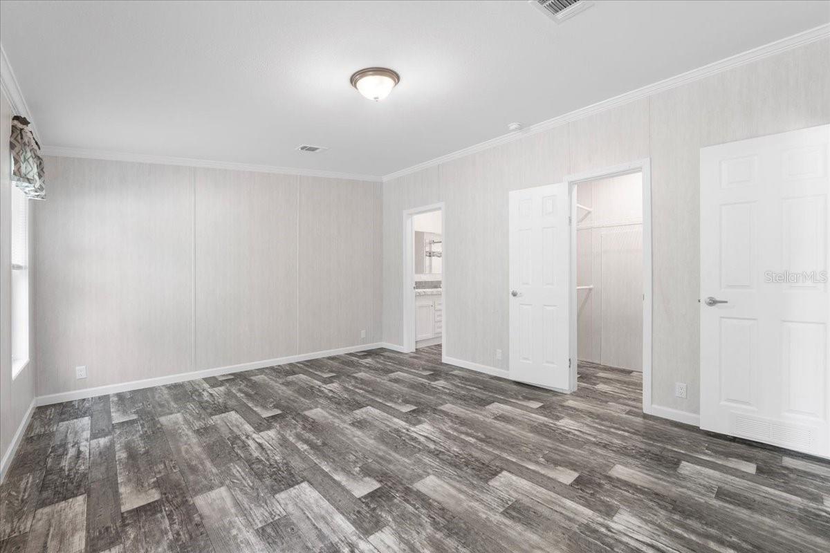 Primary Bedroom w/view of En-Suite & Walk-In Closet Entry