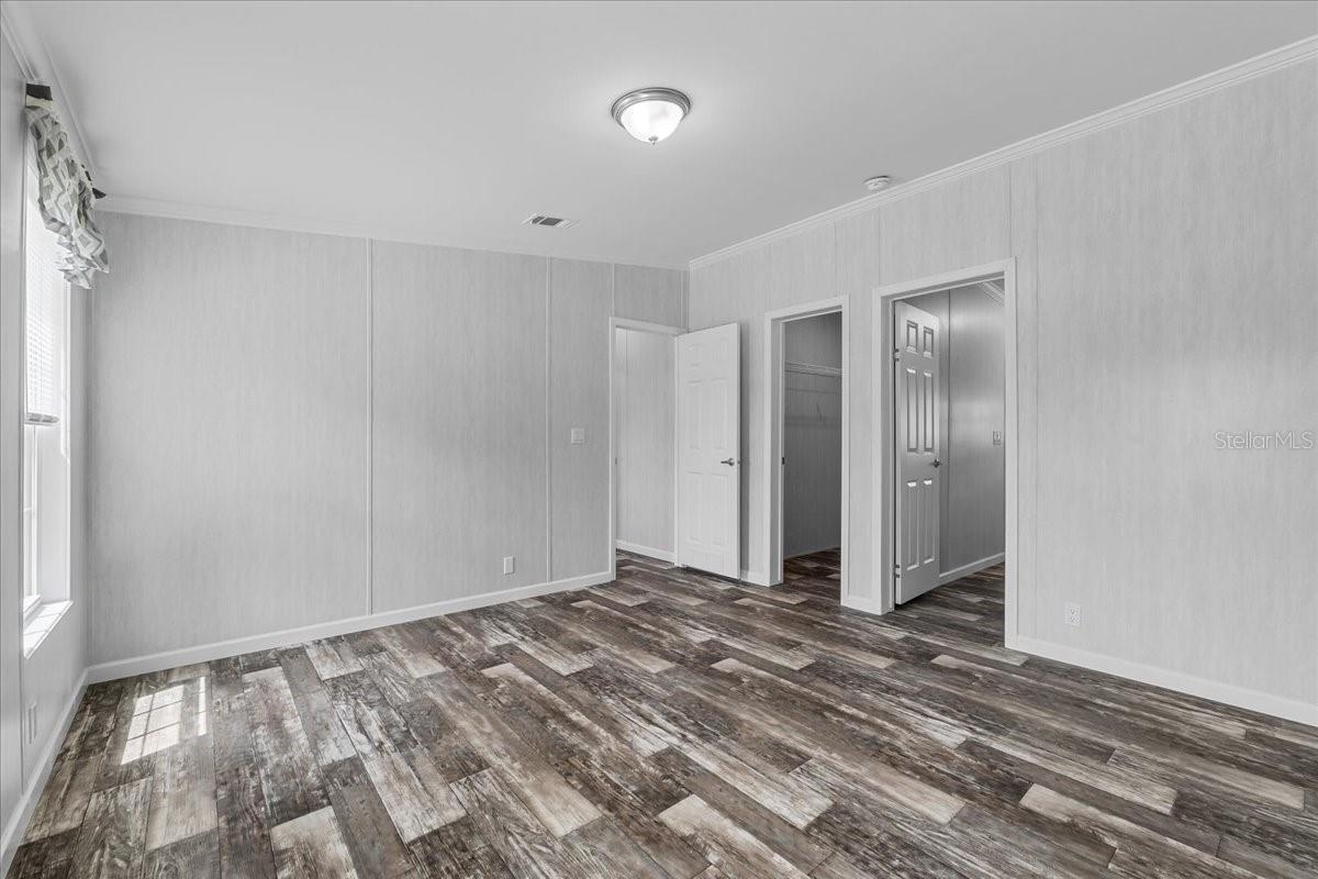 Primary Bedroom Entry w/view of Walk-In Closet & En-suite Bathrrom