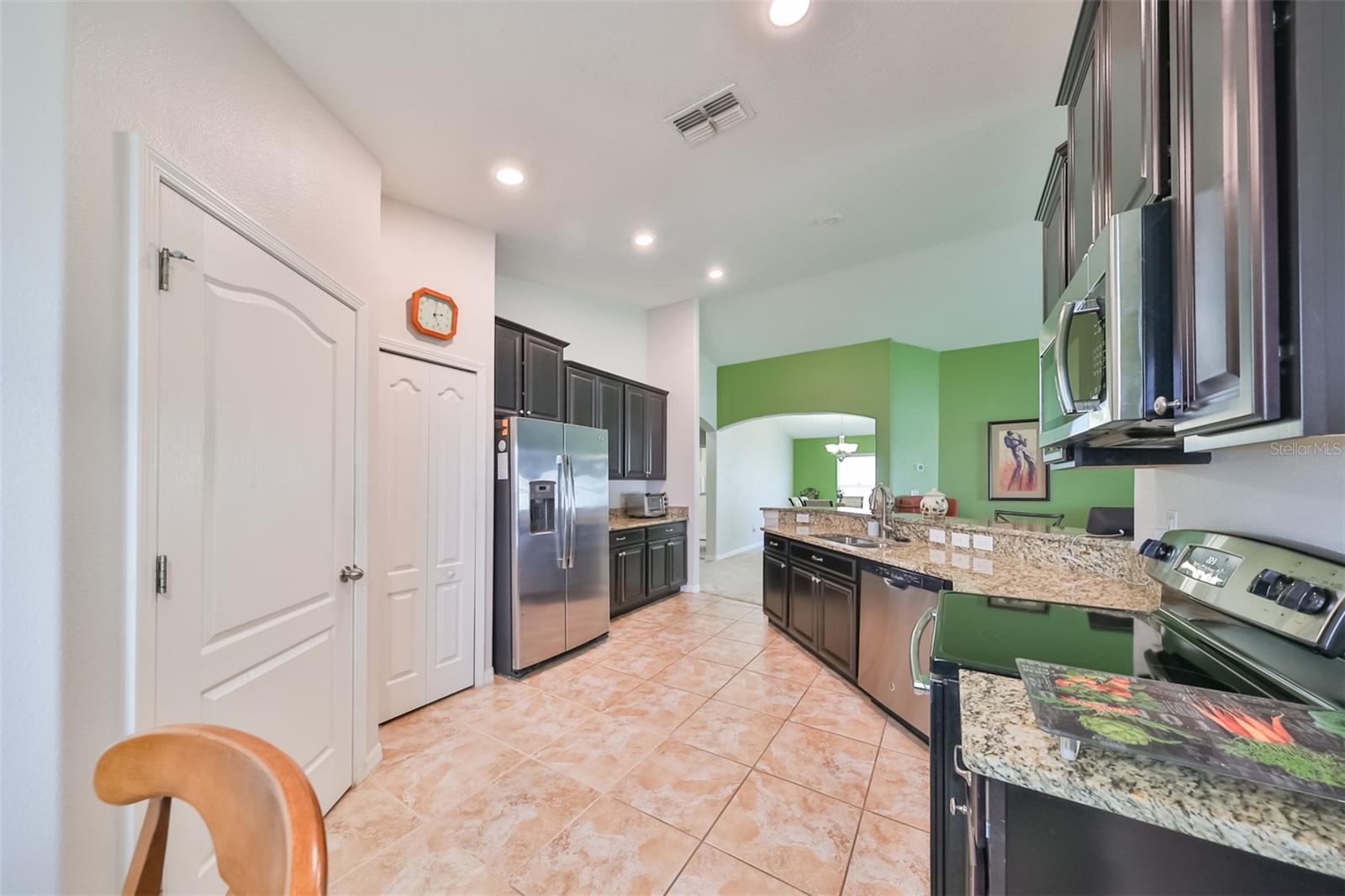 3.2 Gourmet kitchen, stainless steel appliances with tile floor
