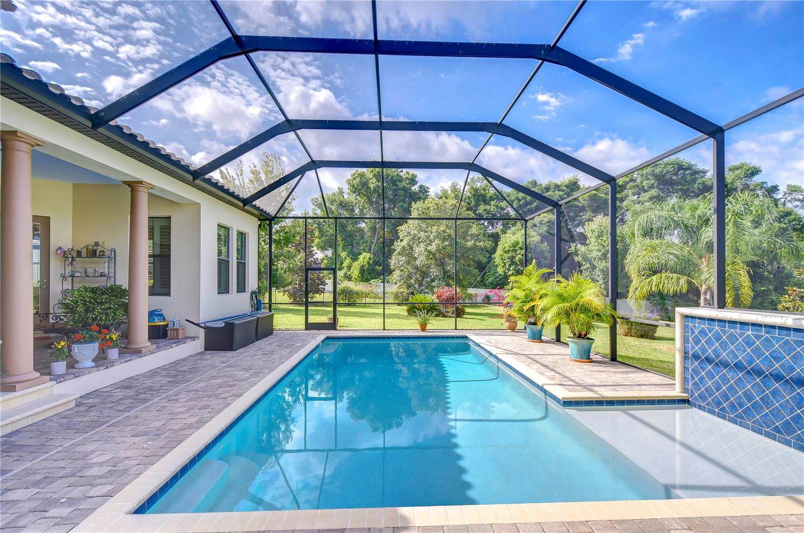 This oversized pool has a sun shelf and pavered patio!