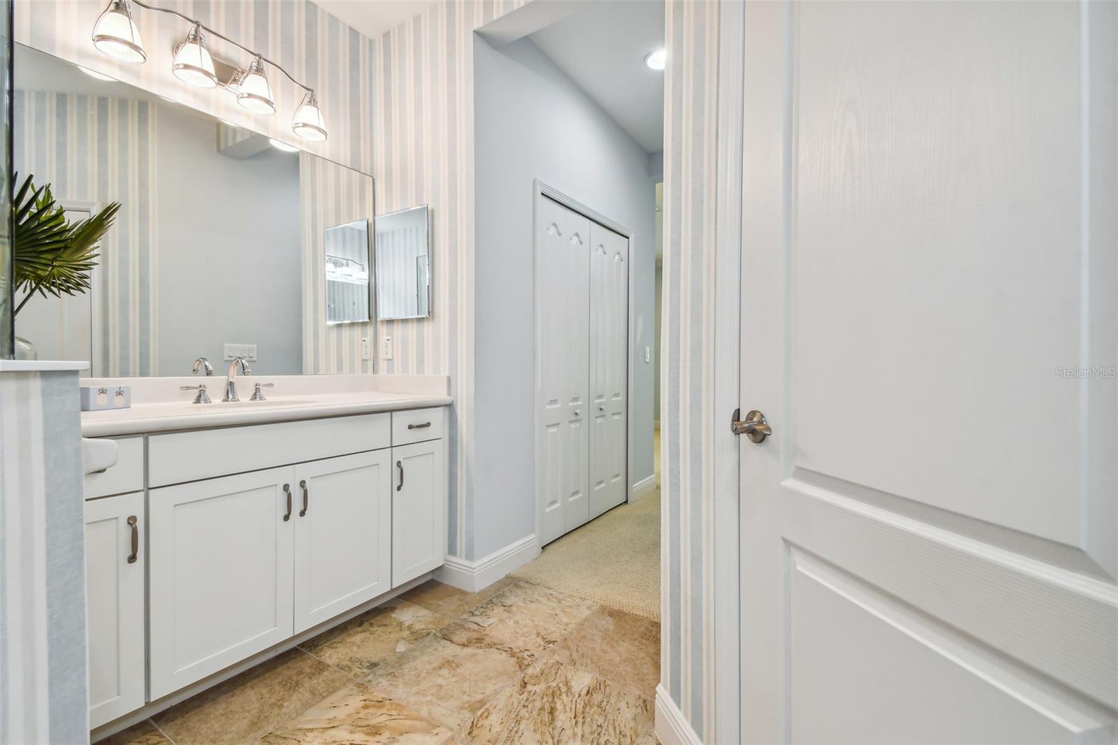 Primary bath with beautiful finishes. Cultured marble counters, designer vanity lights and hardware, elongated water closet, raised panel cabinets, decorator towel bars and fixtures.