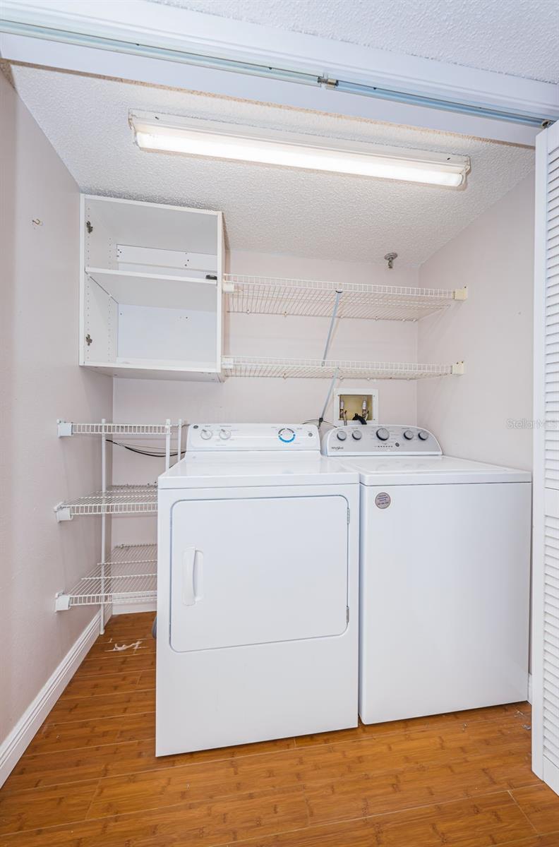 Inside Utility Closet with full sized washer & dryer