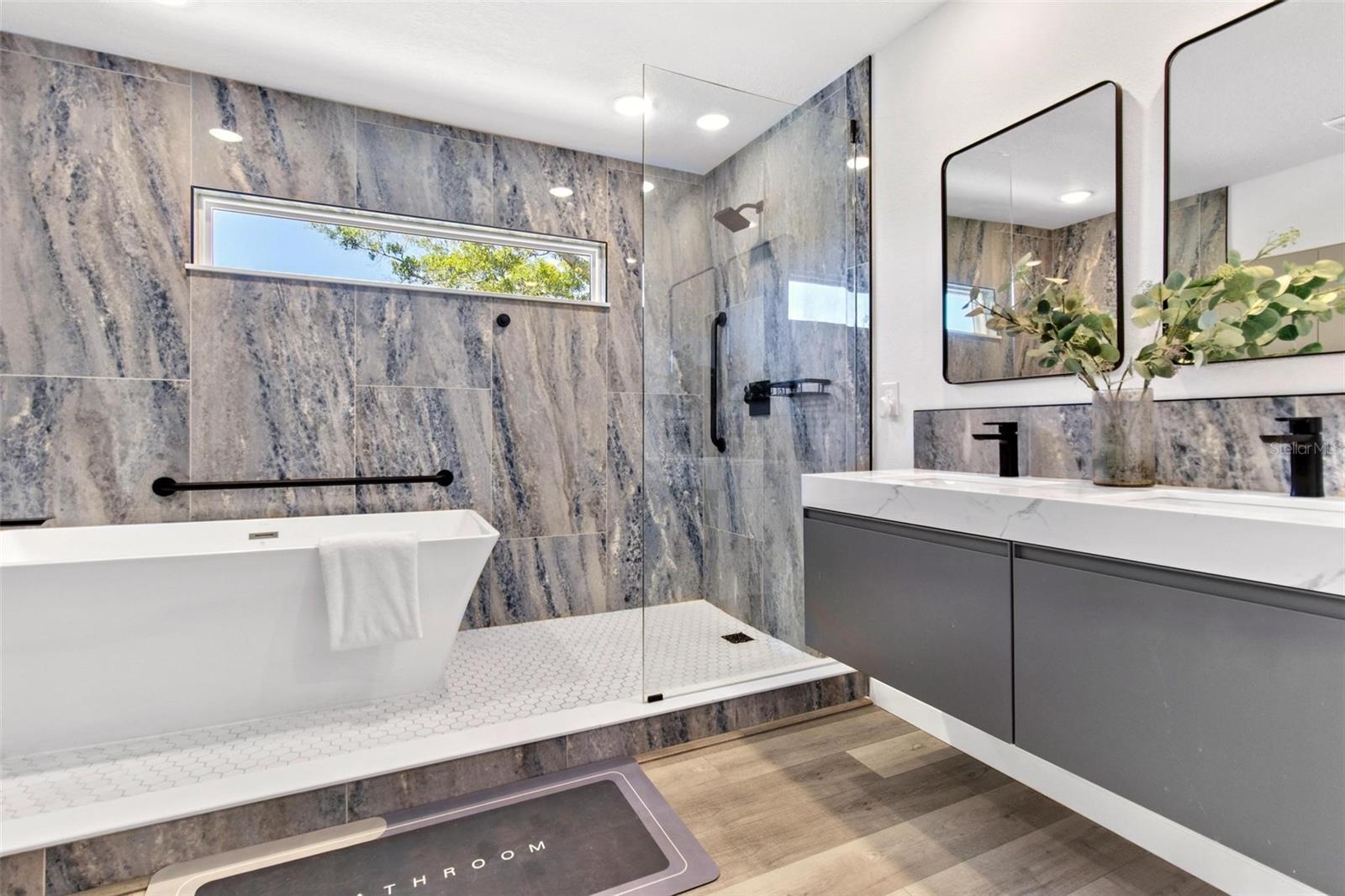 This Spa-like primary ensuite, with floating dual vanity, standalone bathtub, luxury walking shower are a dream.