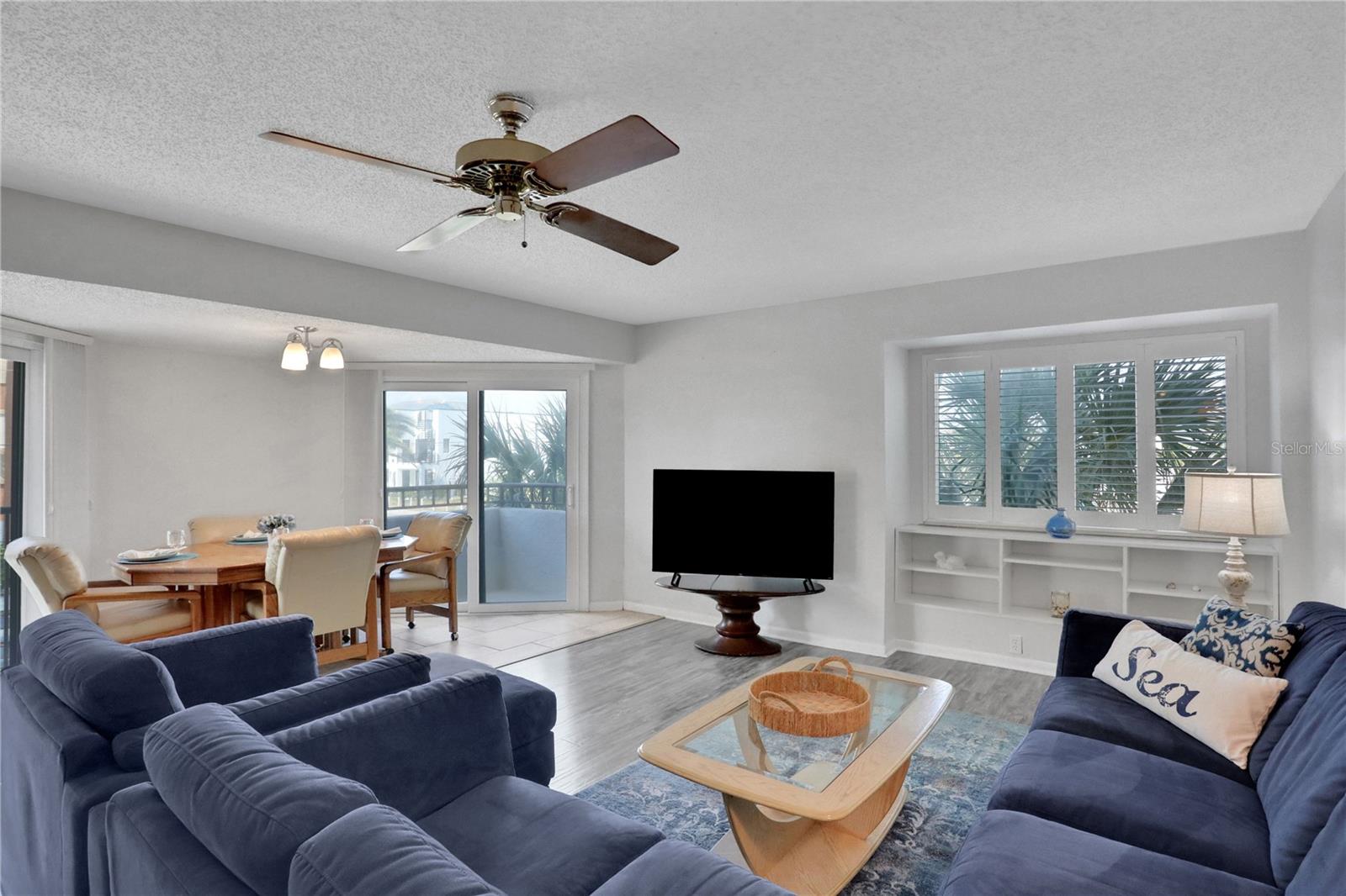 Living room with lovely built-in and custom plantation shutters throughout