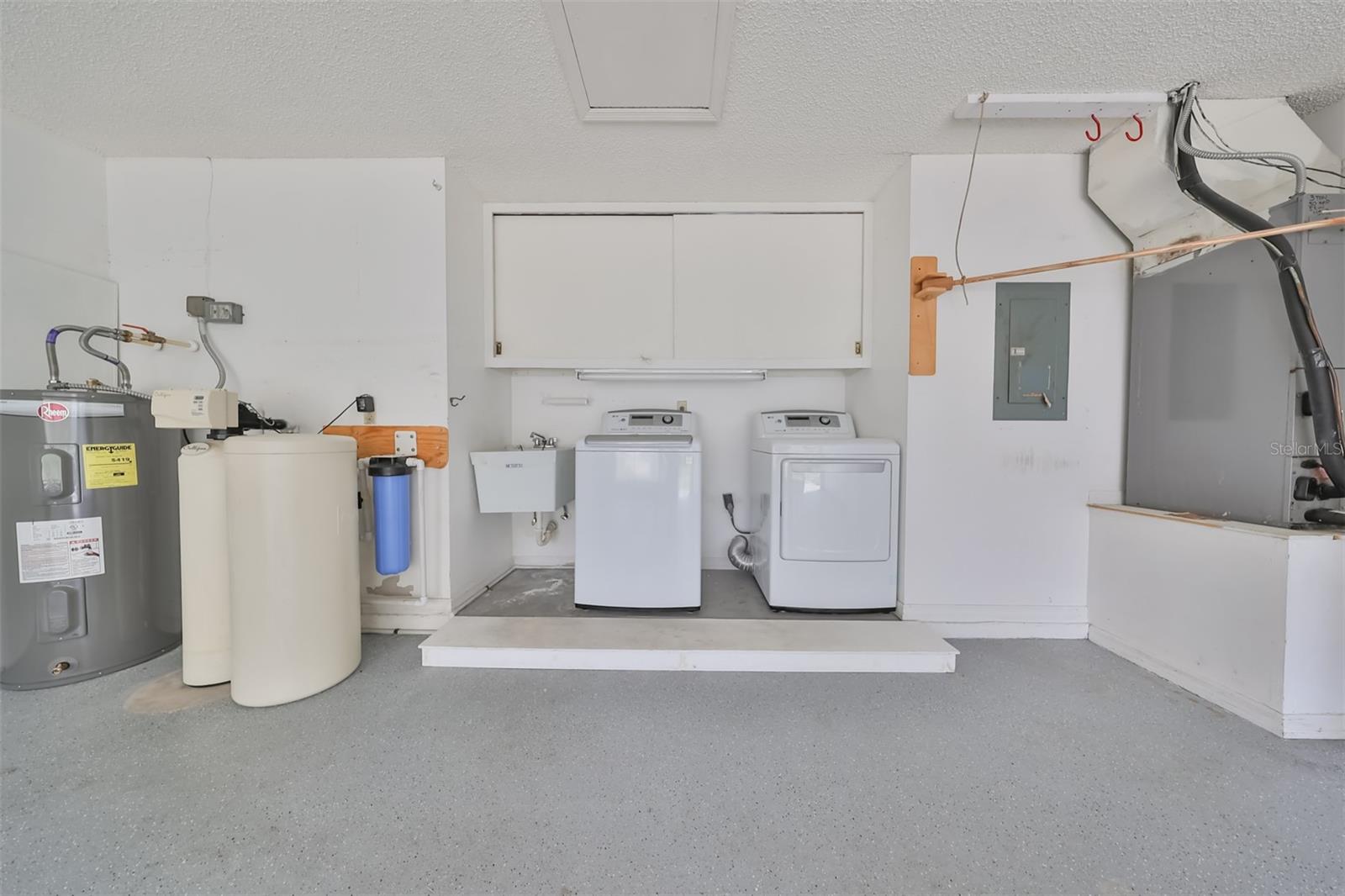 Garage with newer hot water heater & Culligan water softener.