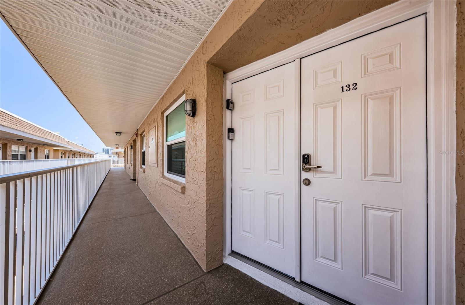 Step into the hallway leading to unit 132, your doorway to comfort and convenience!