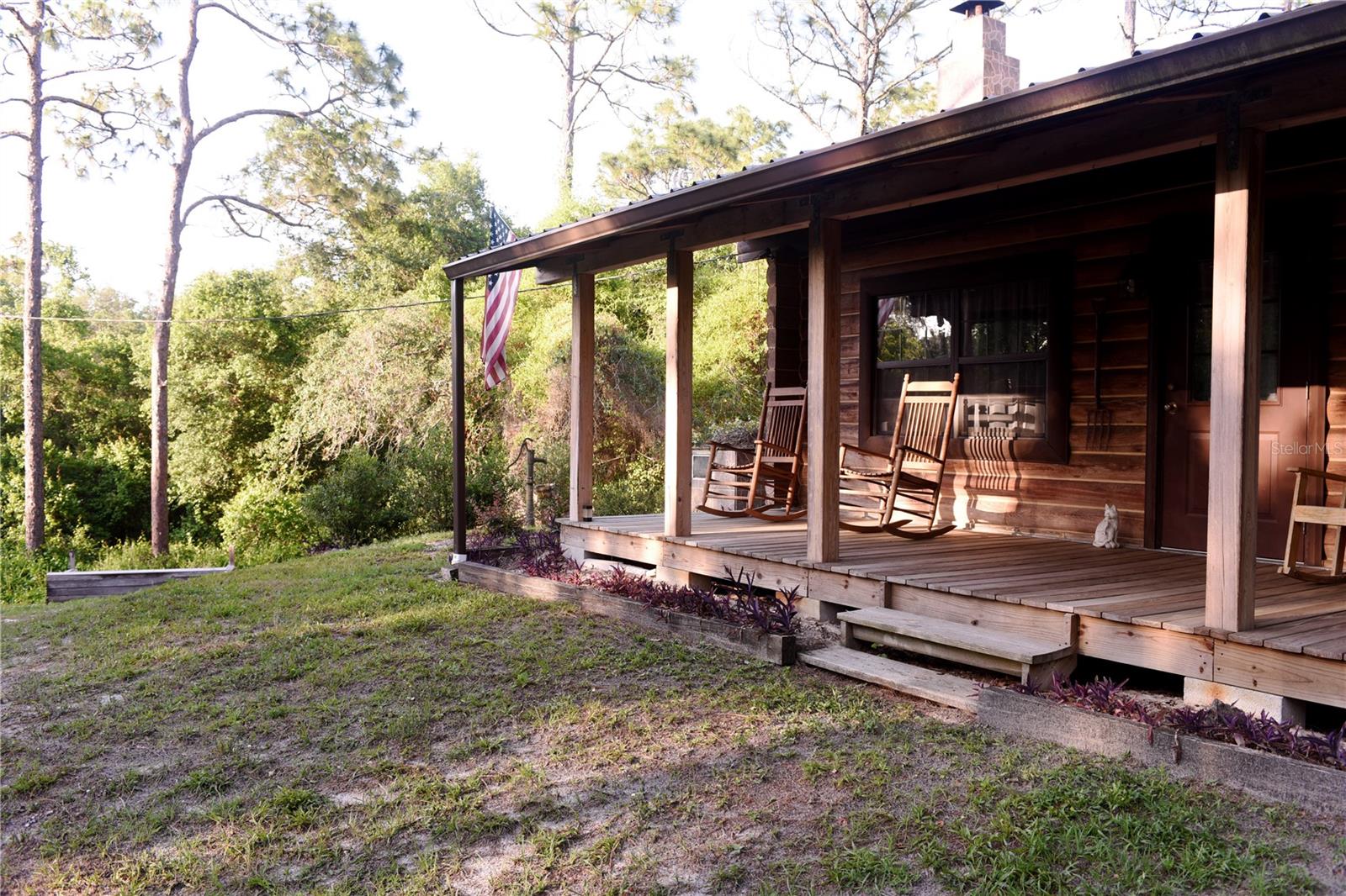 Classic front porch facing wooded front yard