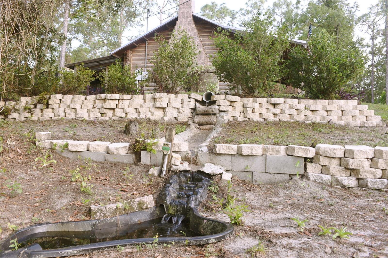 Side yard pond that captures rainwater and runs into pond