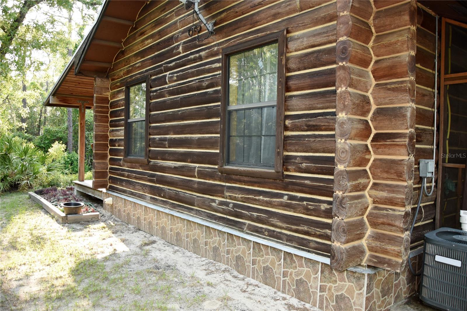 Base trim of solid tile to keep logs out of dirt