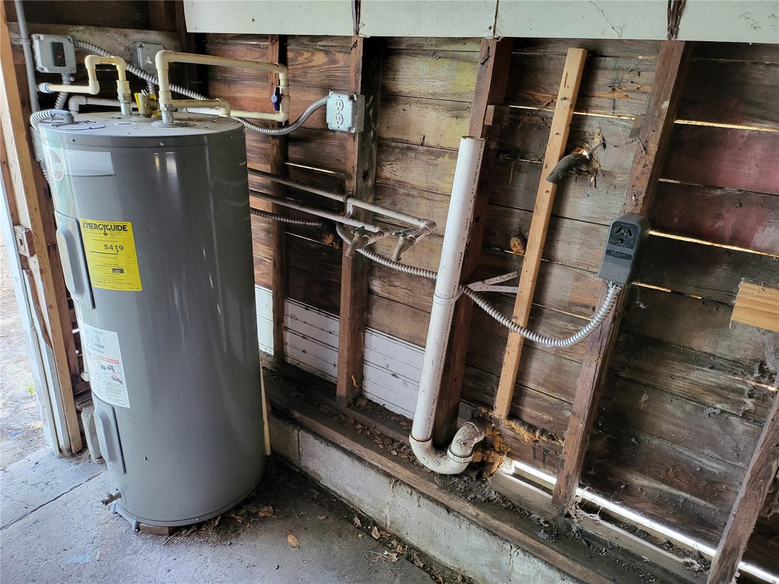 Hot water heater and washer/dryer hookups in garage