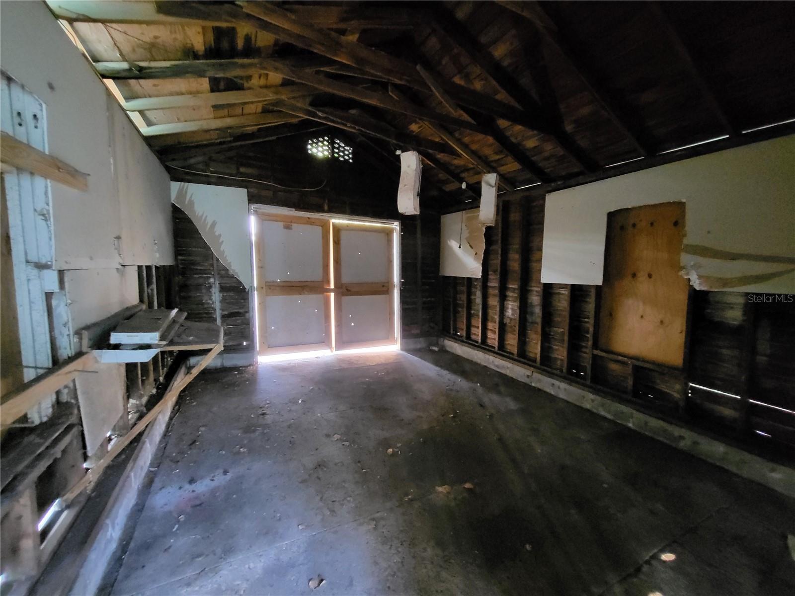 Unfinished garage has potential!  Transform this space into a workshop, garage, gameroom or possibly even an efficiency rental unit