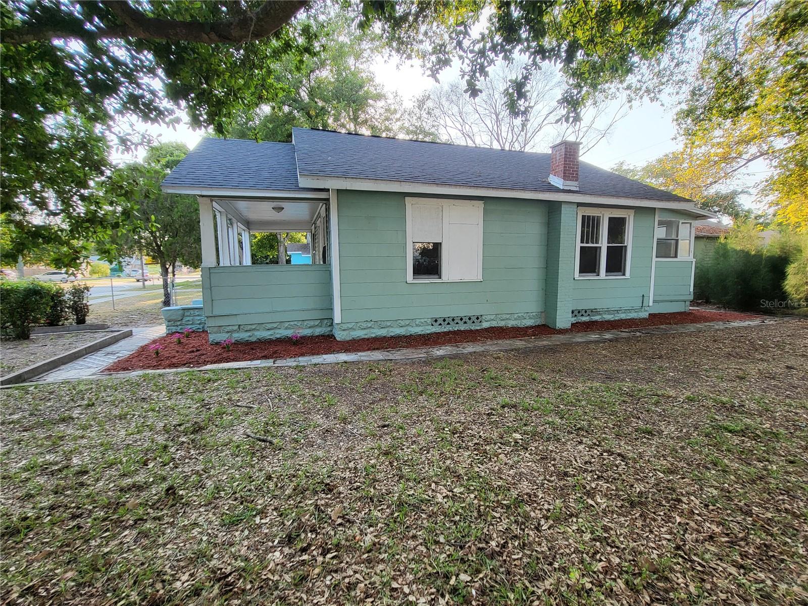 Side view of house.  Roof replaced in 2019!  Add a fence from front to back to fully fence the property.  Vacant lot next door within the fenced area is NOT included.