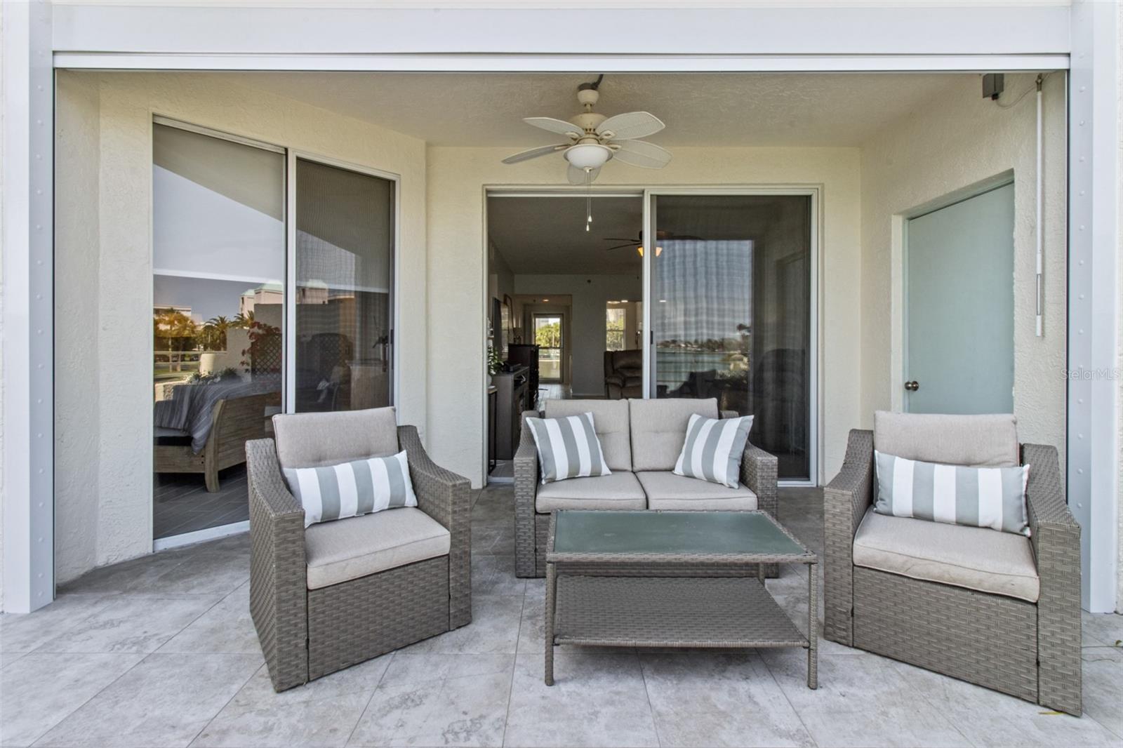 Step outside from both the living room & primary bedroom to be embraced by breathtaking azure water vistas.