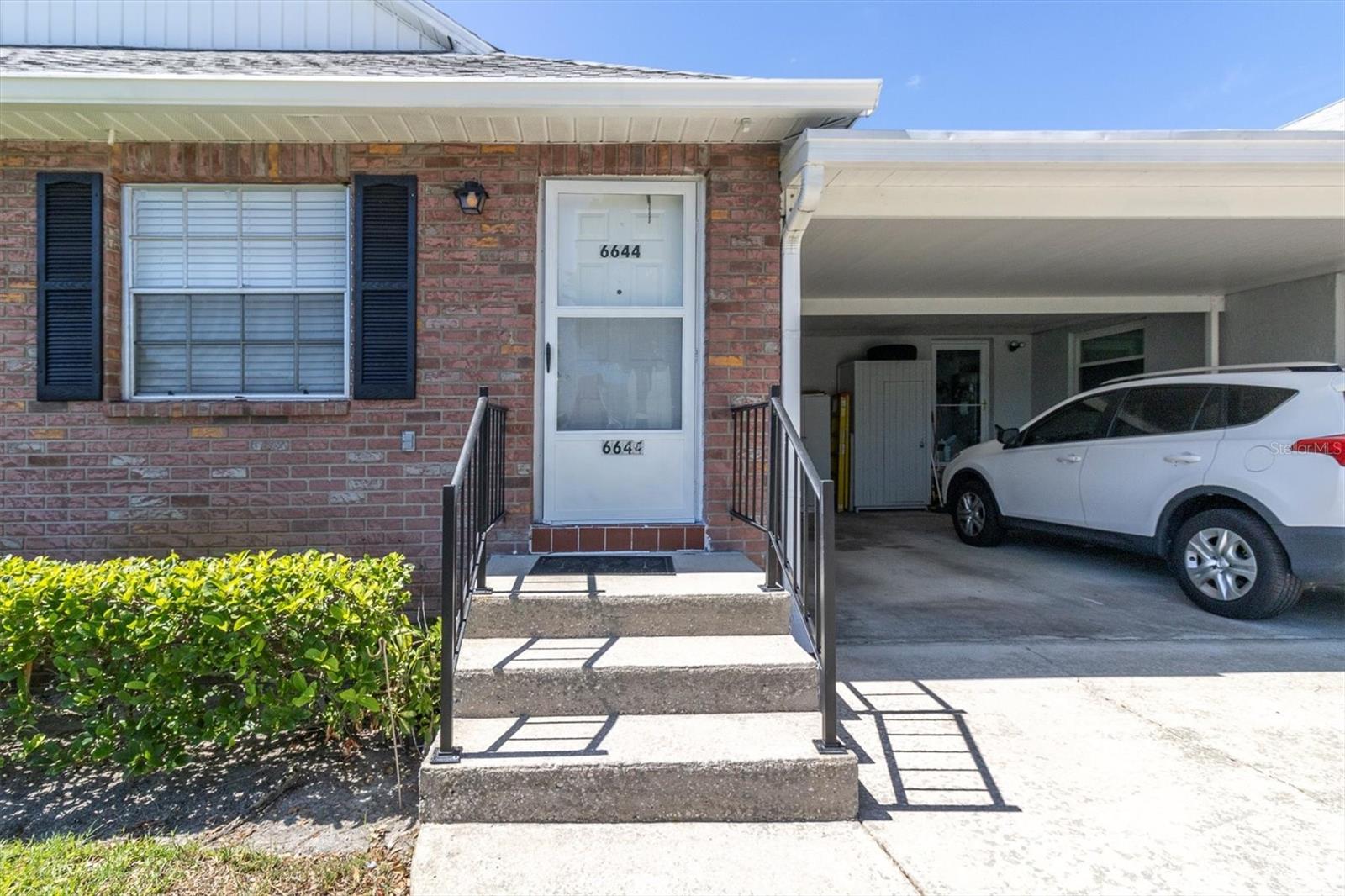 Attached Carport with covered entry door into condo