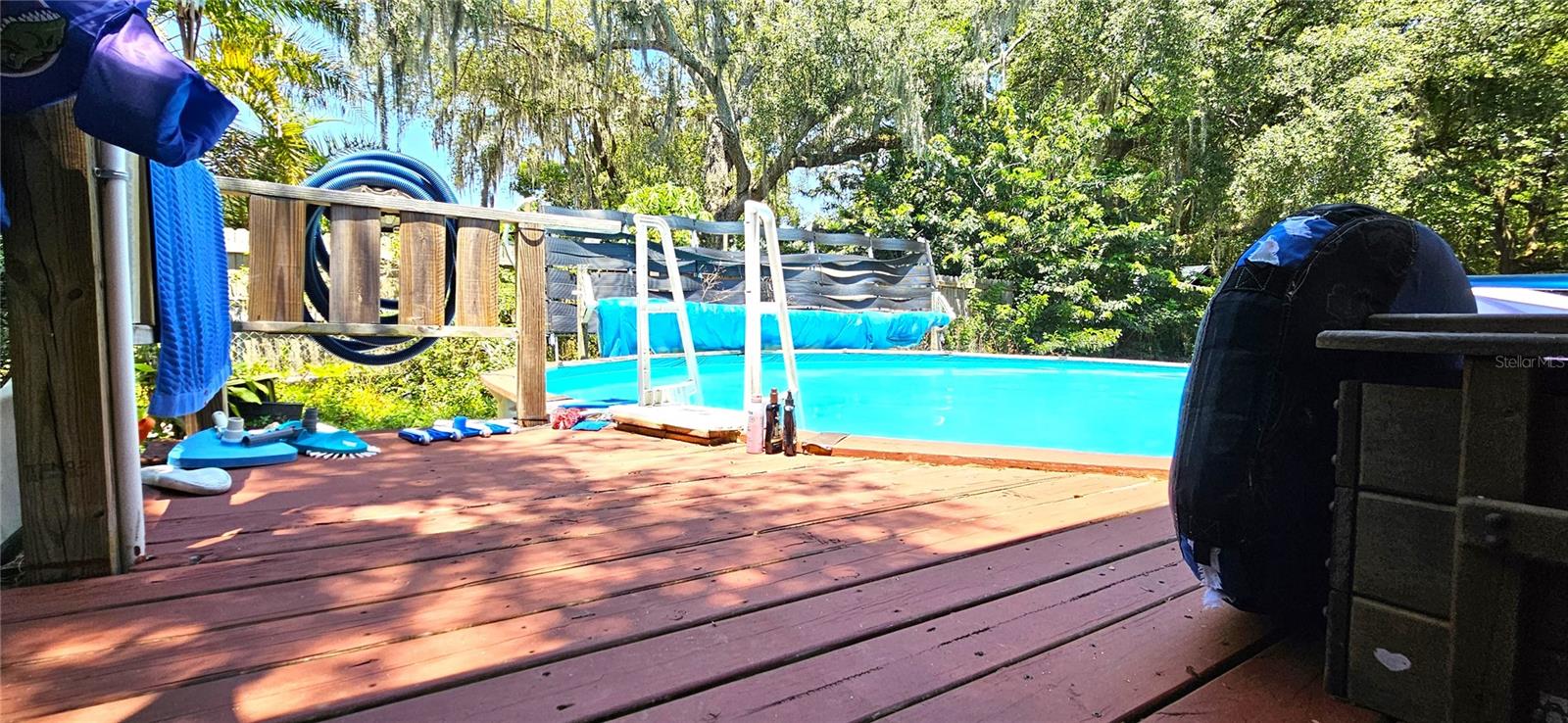 Fenced backyard, above ground pool, wood deck, screened in lanai