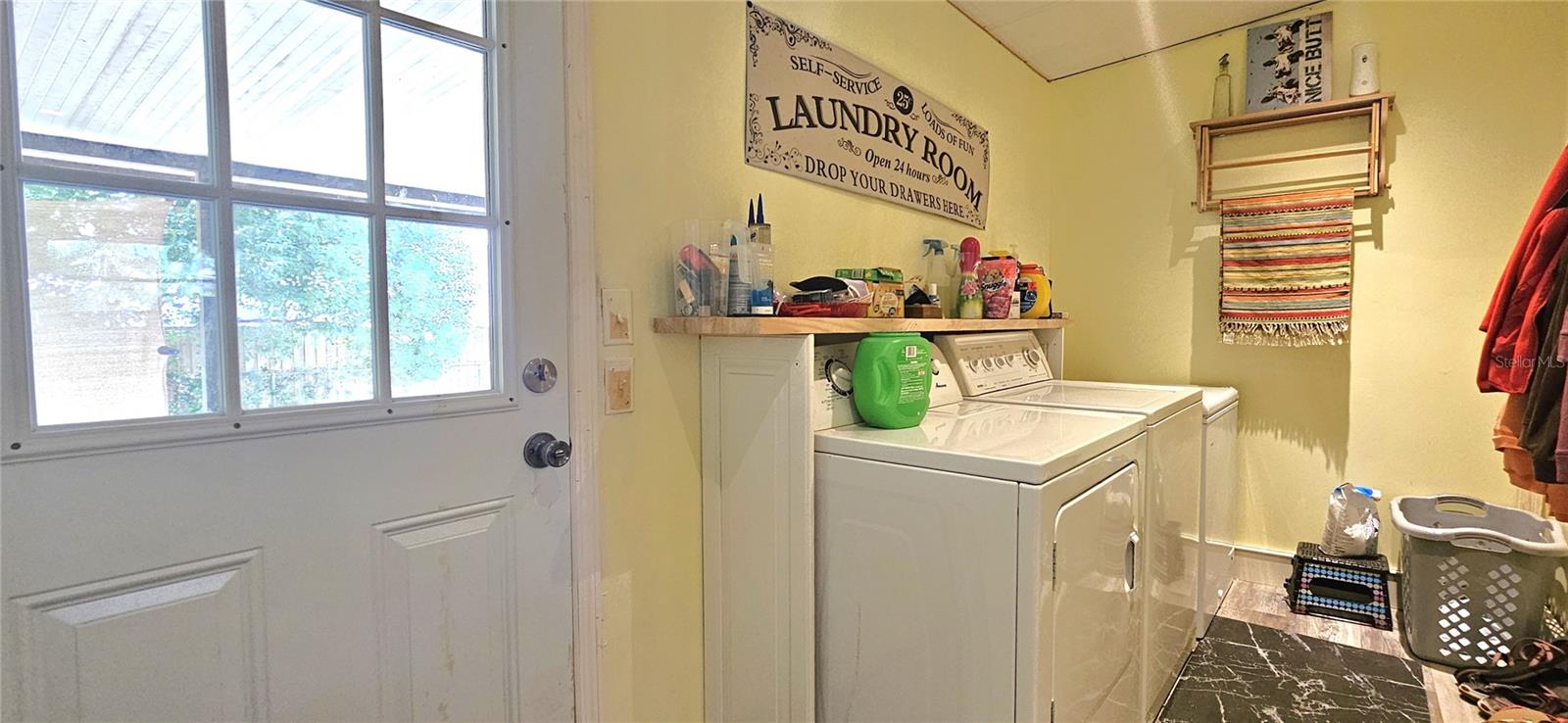 Inside laundry room includes side by side washer & dryer
