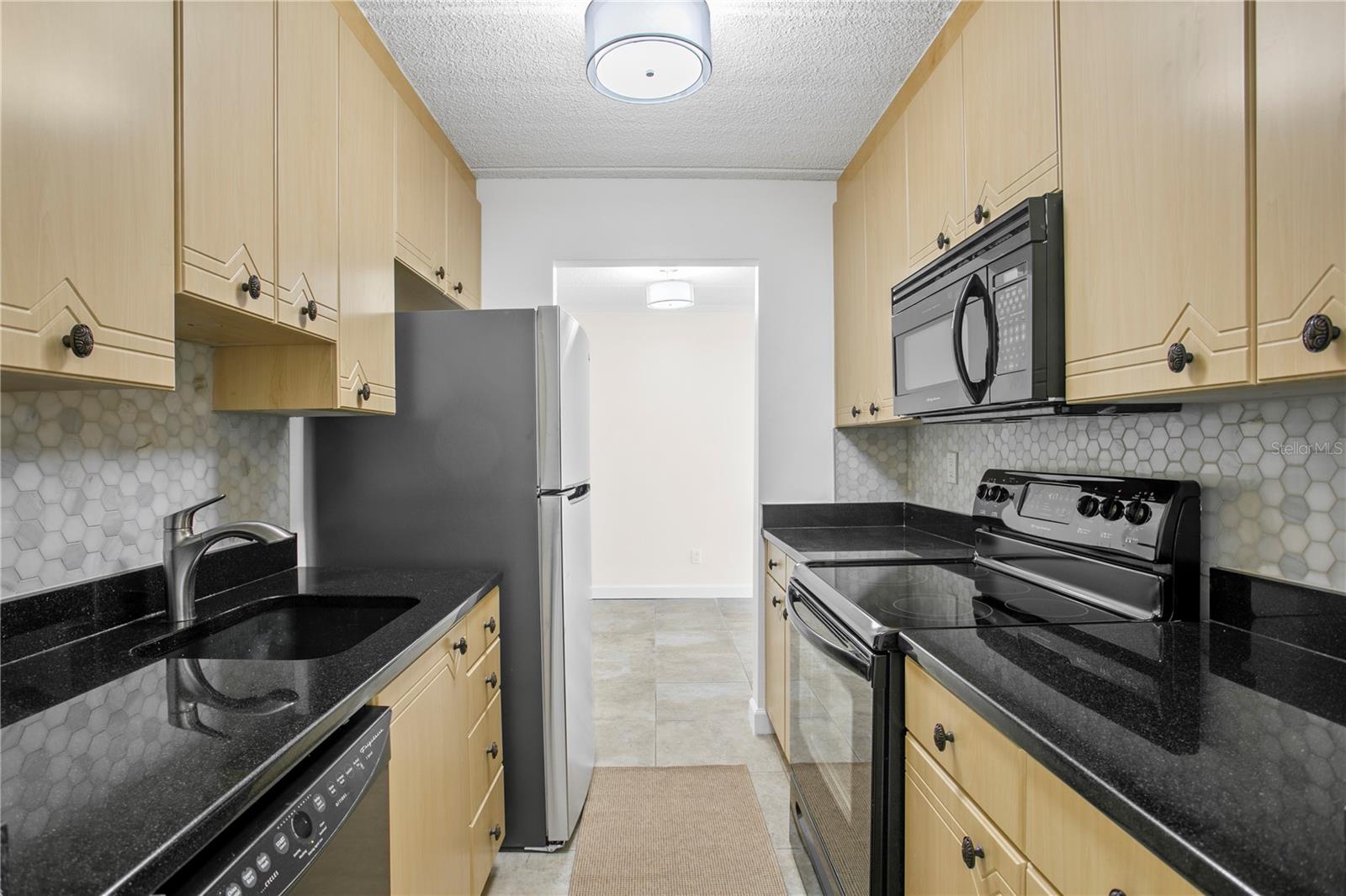 Nicely updated kitchen with stainless appliances and light cabinetry