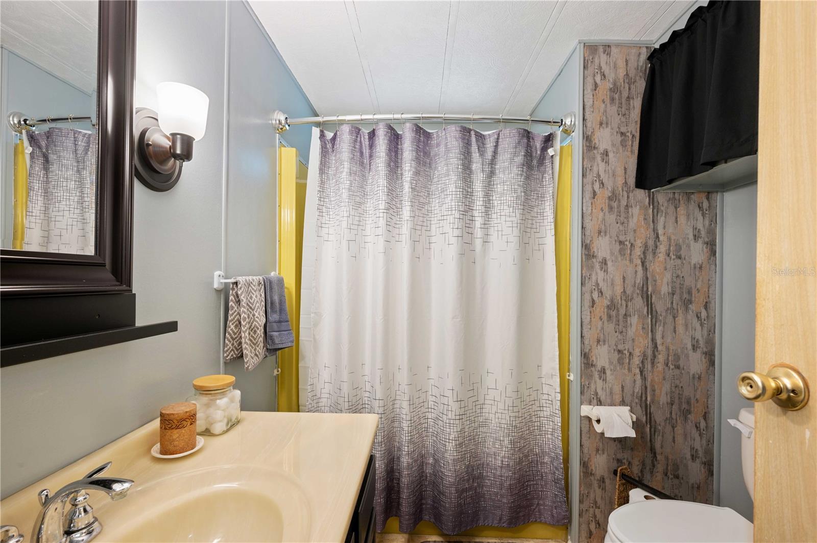 Guest bathroom has tub/shower combo.