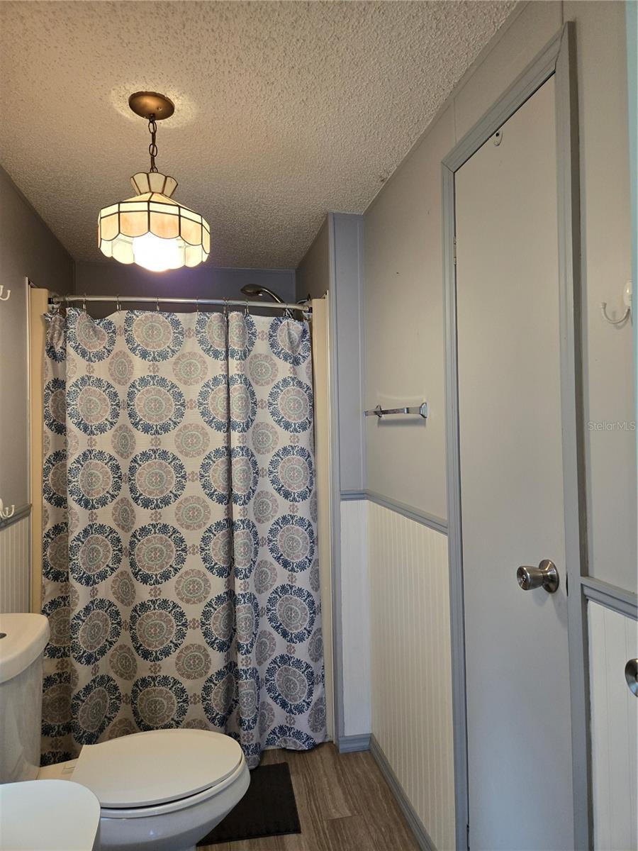 Primary Bathroom: Shower only with handicapped rail and builtin bench - Linen Closet