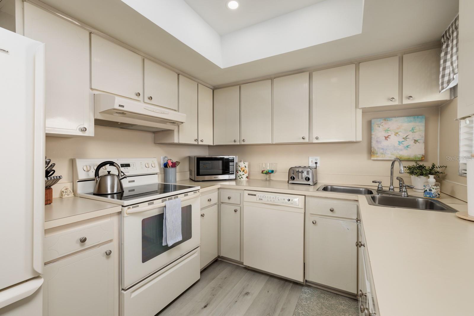 Kitchen w/corner double sink & large closet pantry. Window over sink.