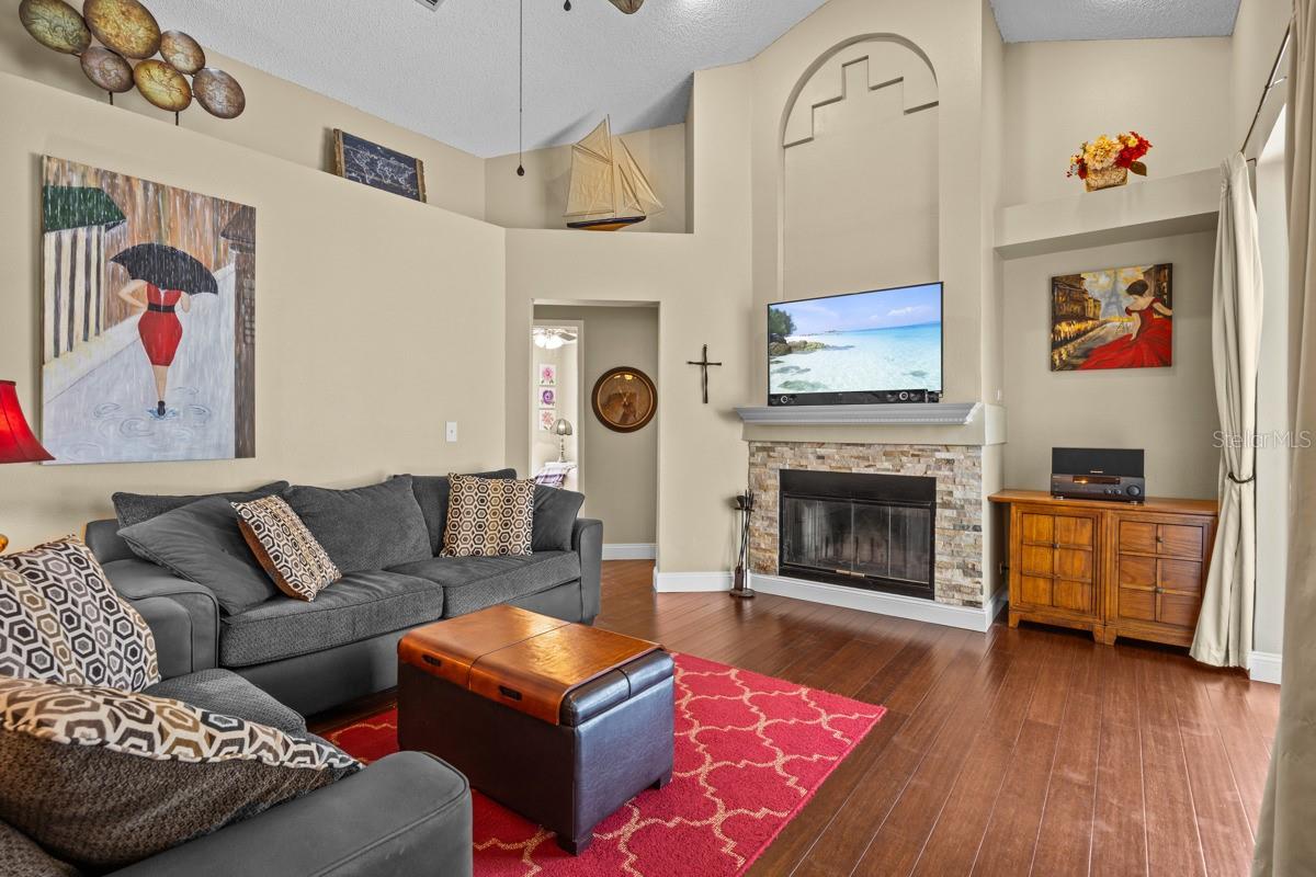 Family Room with Vaulted Ceilings and wood burning Fireplace