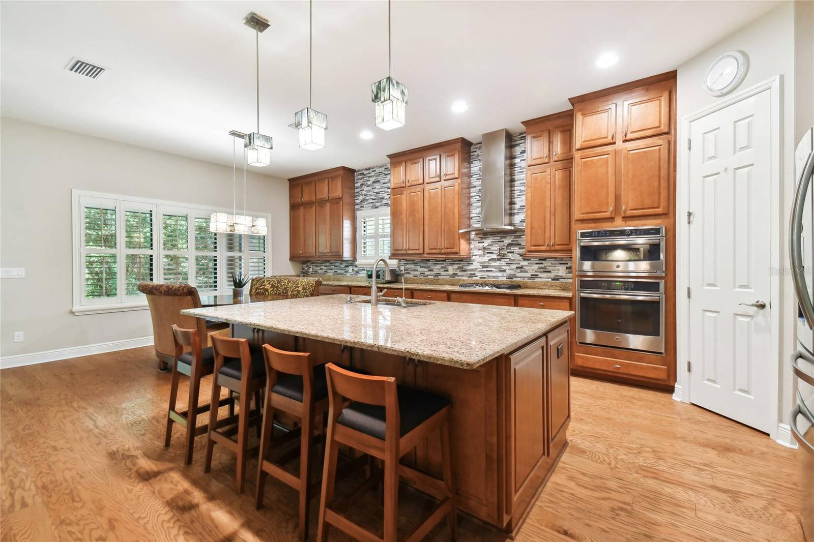 Gourmet Kitchen with Wooden extended cabinets, pot filler, gas stove, wall oven and convection oven.  Large Pantry and eating area in kitchen.