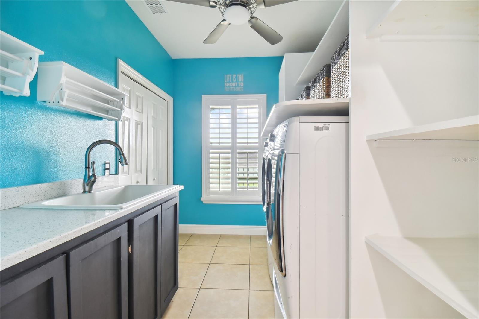 Upstairs Laundry Room with closet pantry storage, laundry sink, and plenty of storage space.