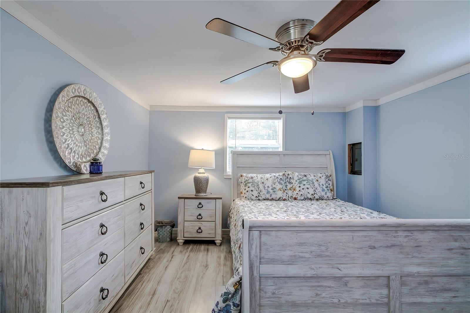 Dresser and night table fit well with a queen sized bed (even if it looks smaller)  Electrical panel on the wall