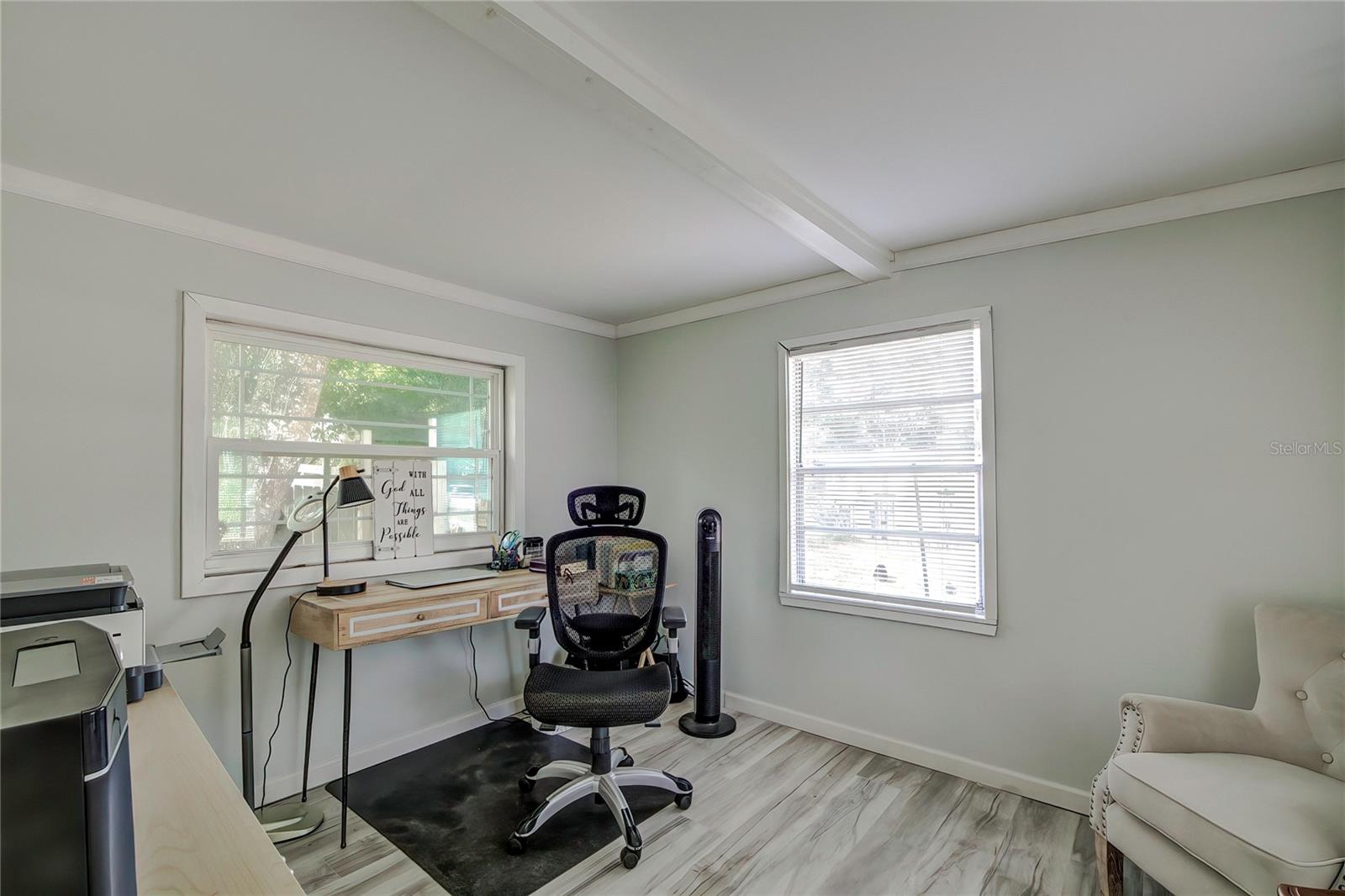 Living room also accommodates an office, with plenty of natural light