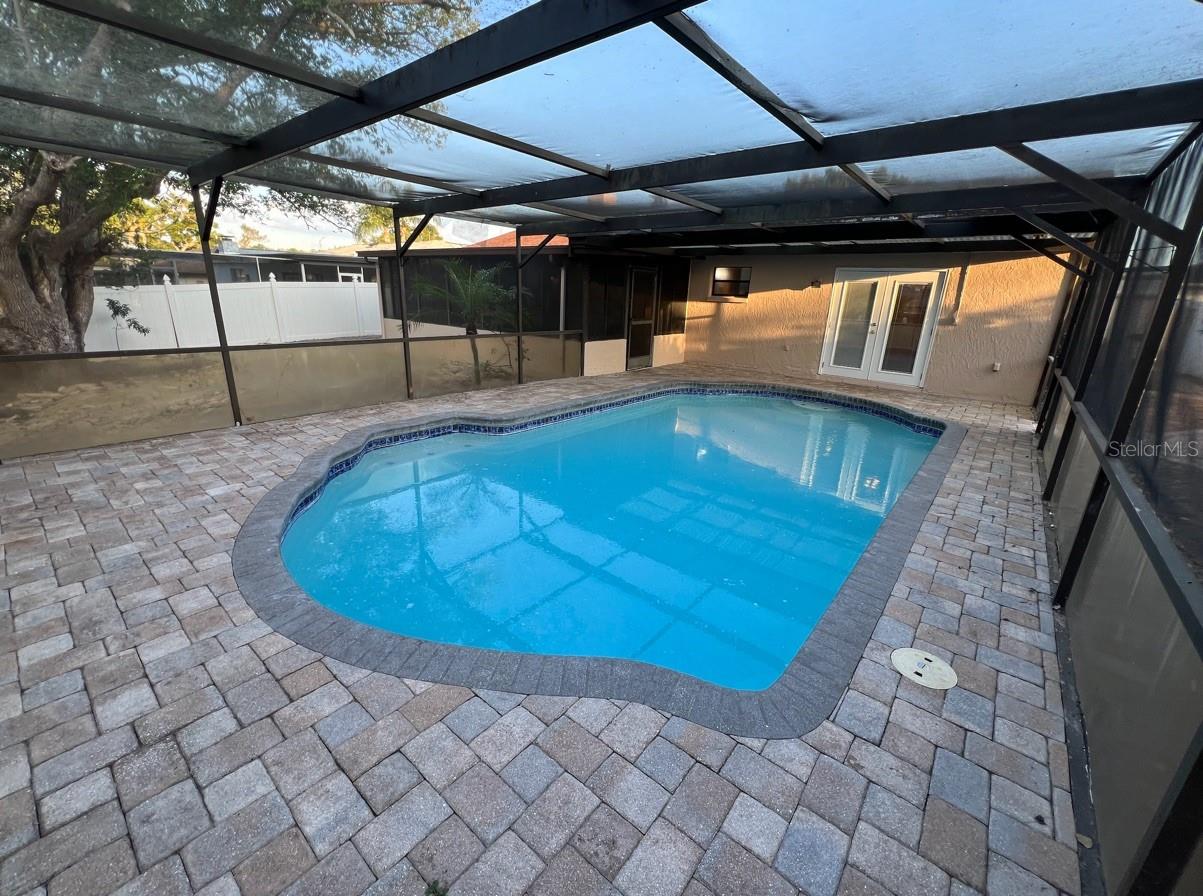 pool view of primary French doors