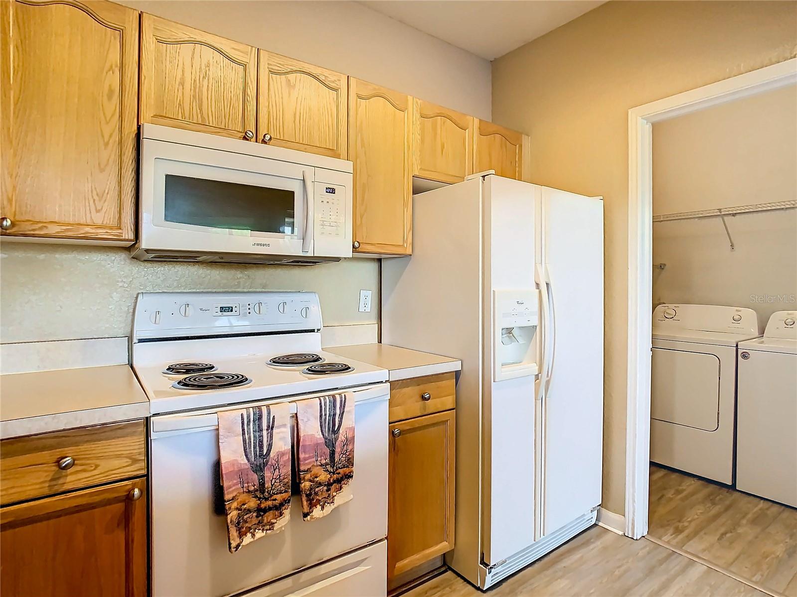 From here you can see the laundry room. Behind you is the sink plus breakfast bar.