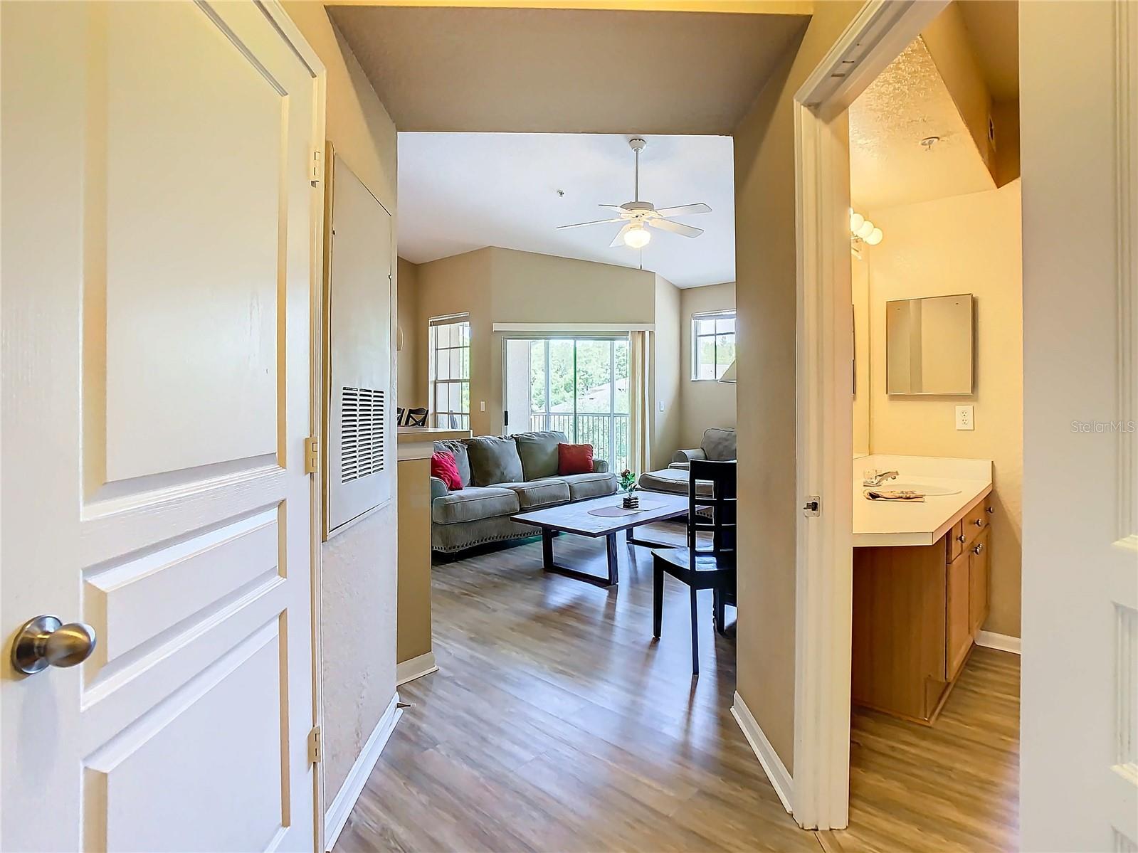 At front door. Straight ahead is the great room. To the right is entrance to the bath which then leads into bedroom.