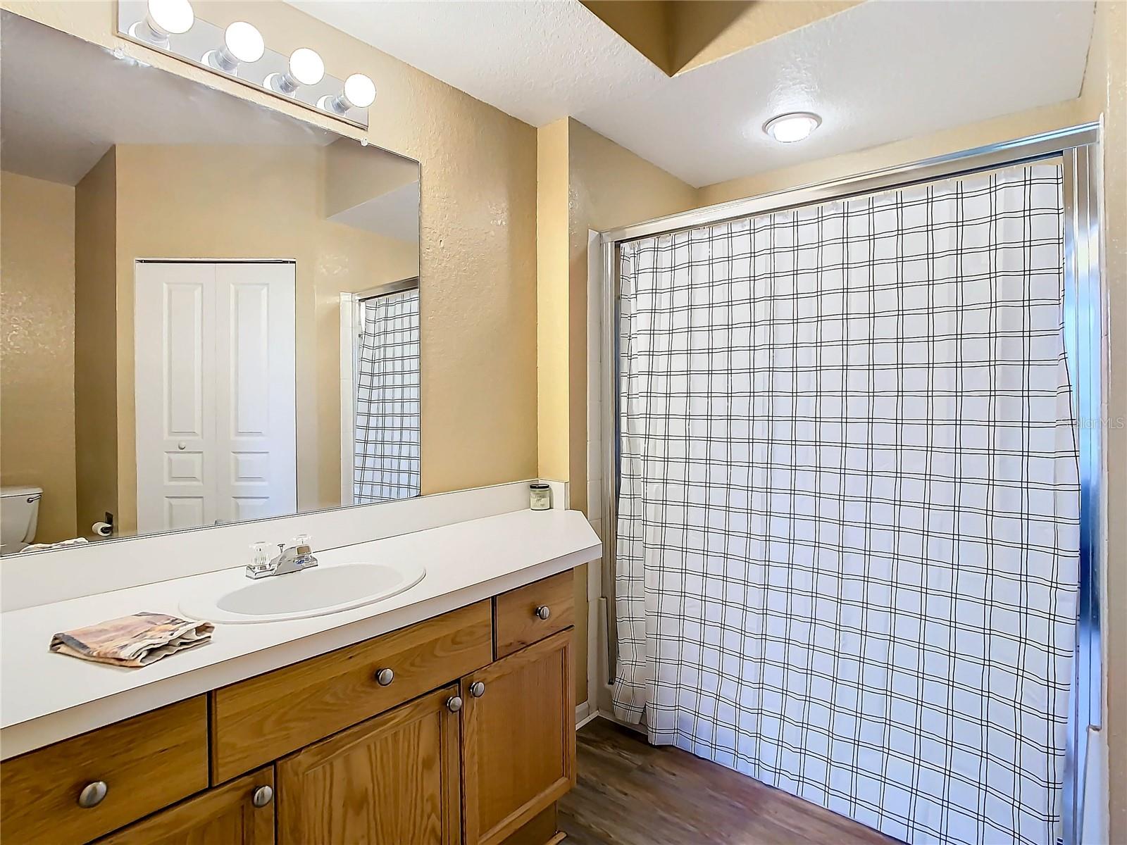 En-suite bath of primary bedroom. This one is a shower (no tub)