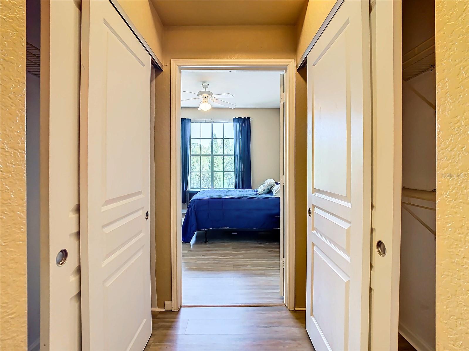 Closets on both sides. Behind you is the en-suite bath.