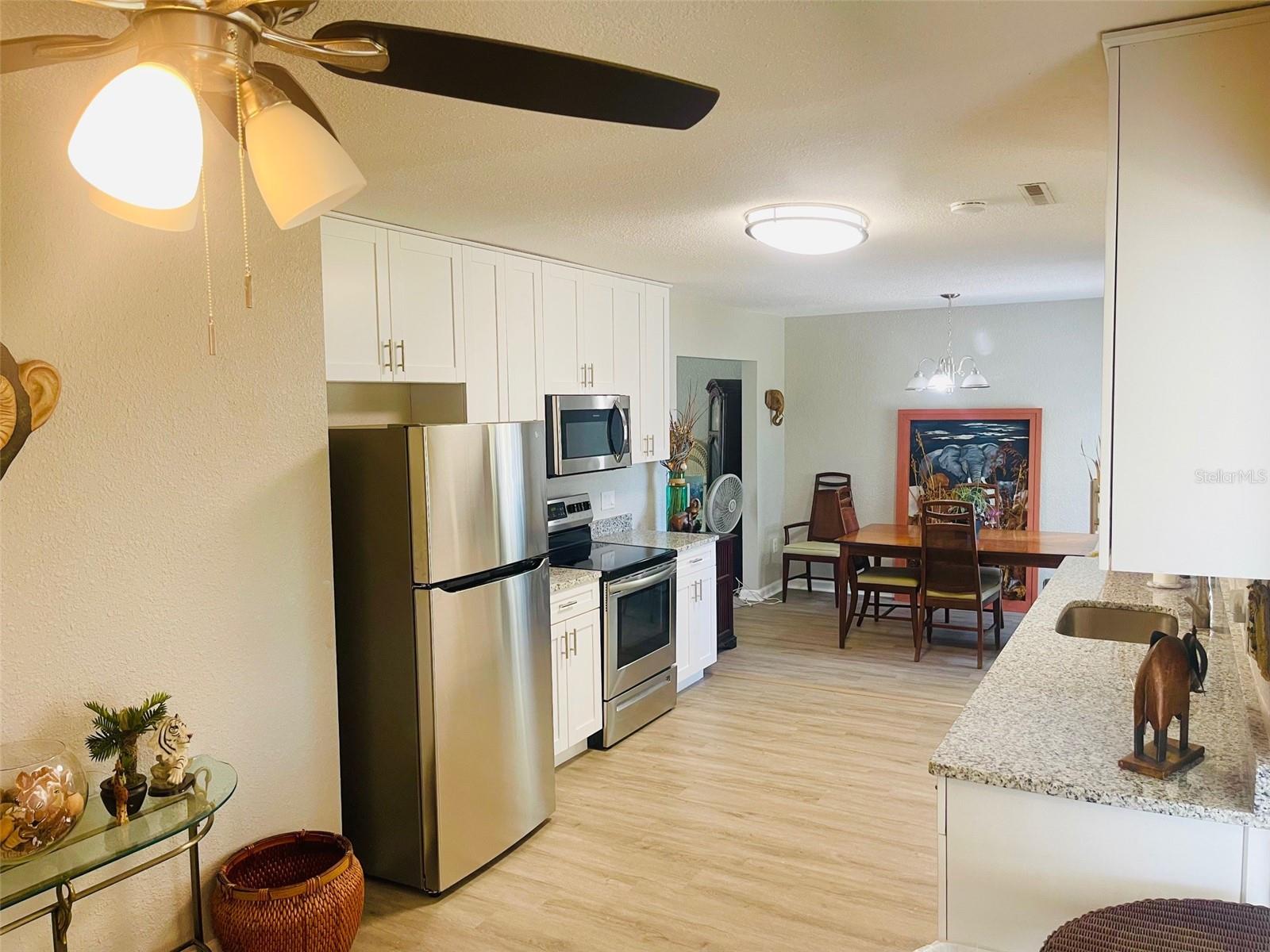 Kitchen and dining room, view from back door that opens to patio.