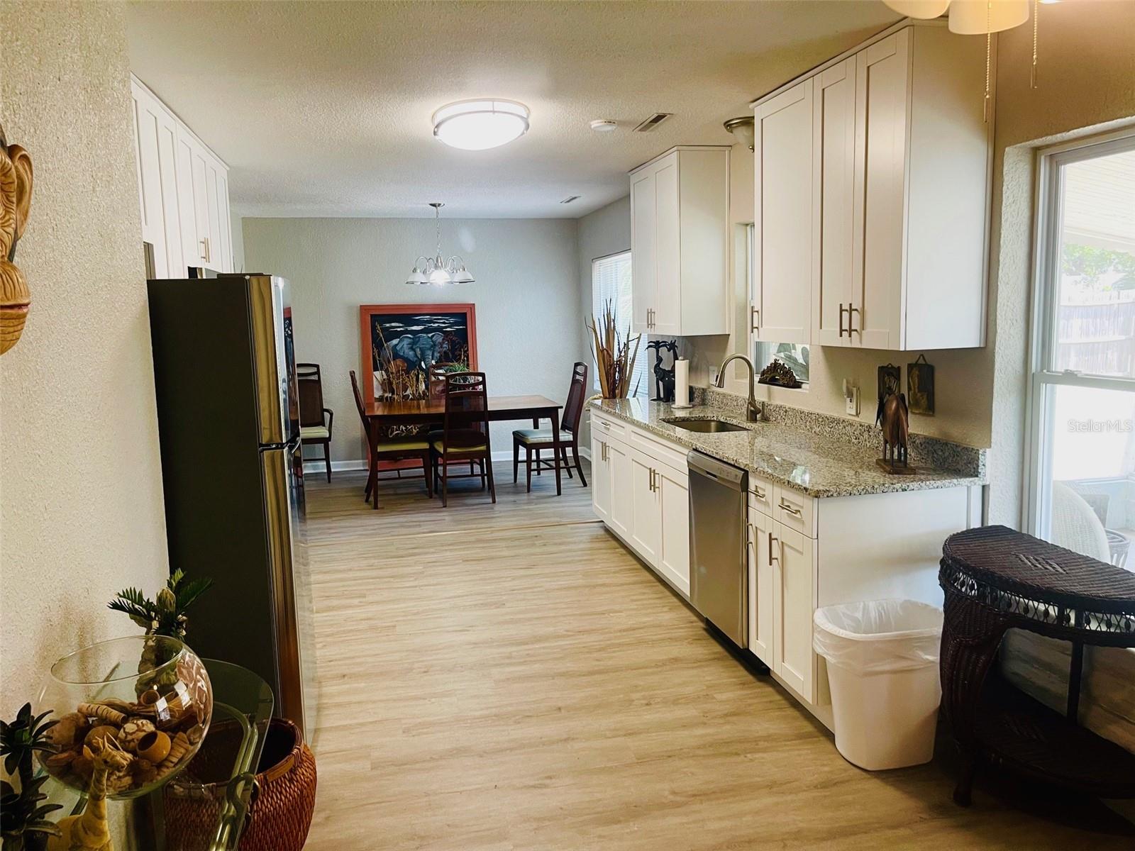 Kitchen and dining room, view from back door that opens to patio.