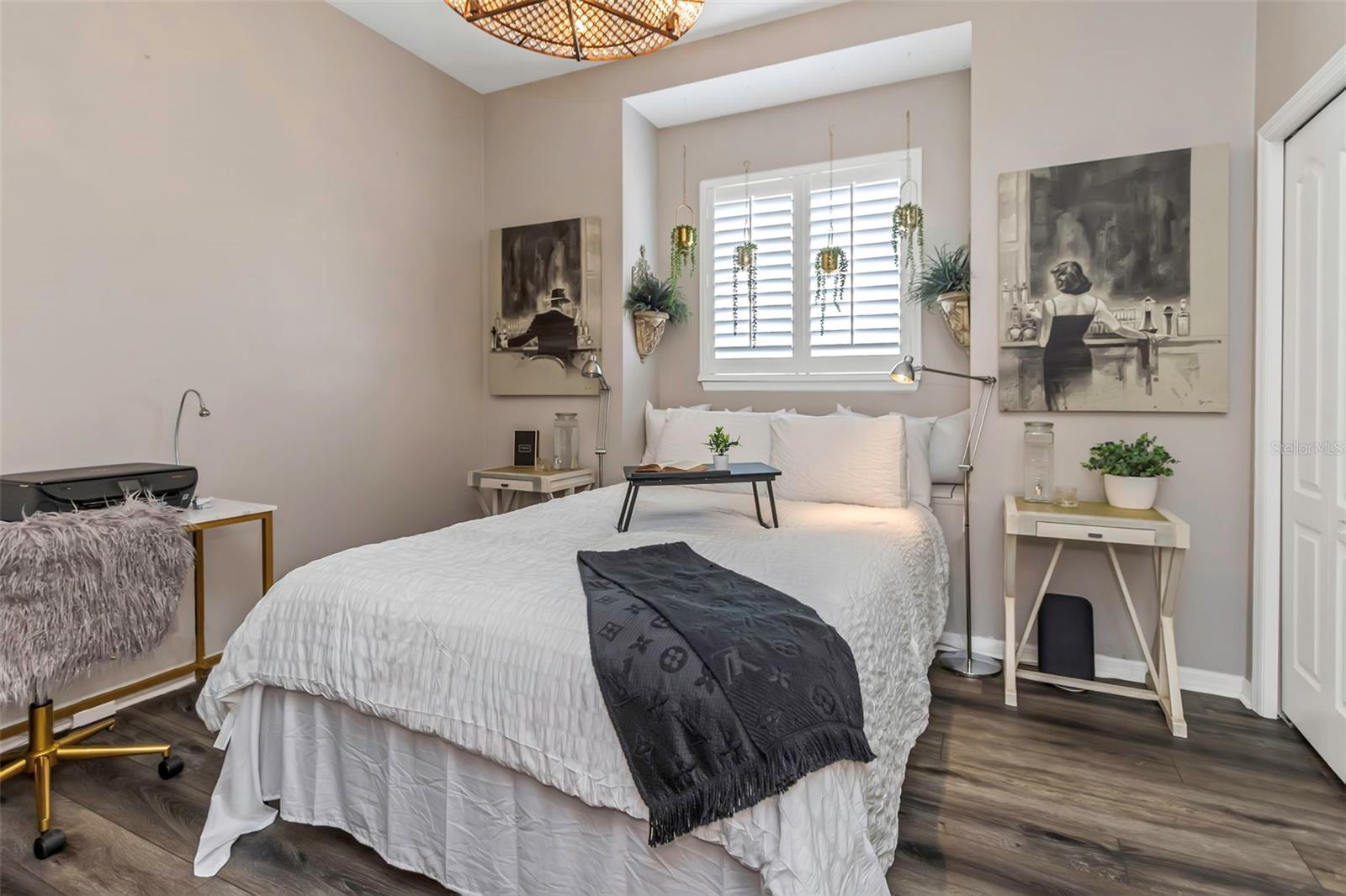 One of the bedrooms with luxury vinyl flooring and charming window seat just behind the bed