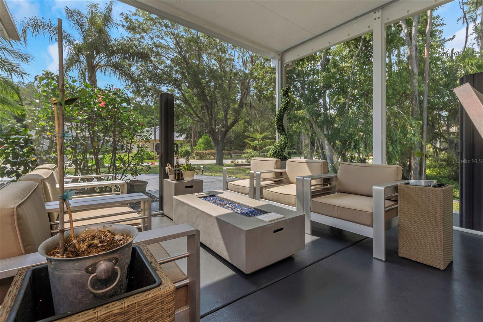 One of the seating areas on the covered lanai with Christopher Knight luxury seating and lighted gas fire pit as center table.