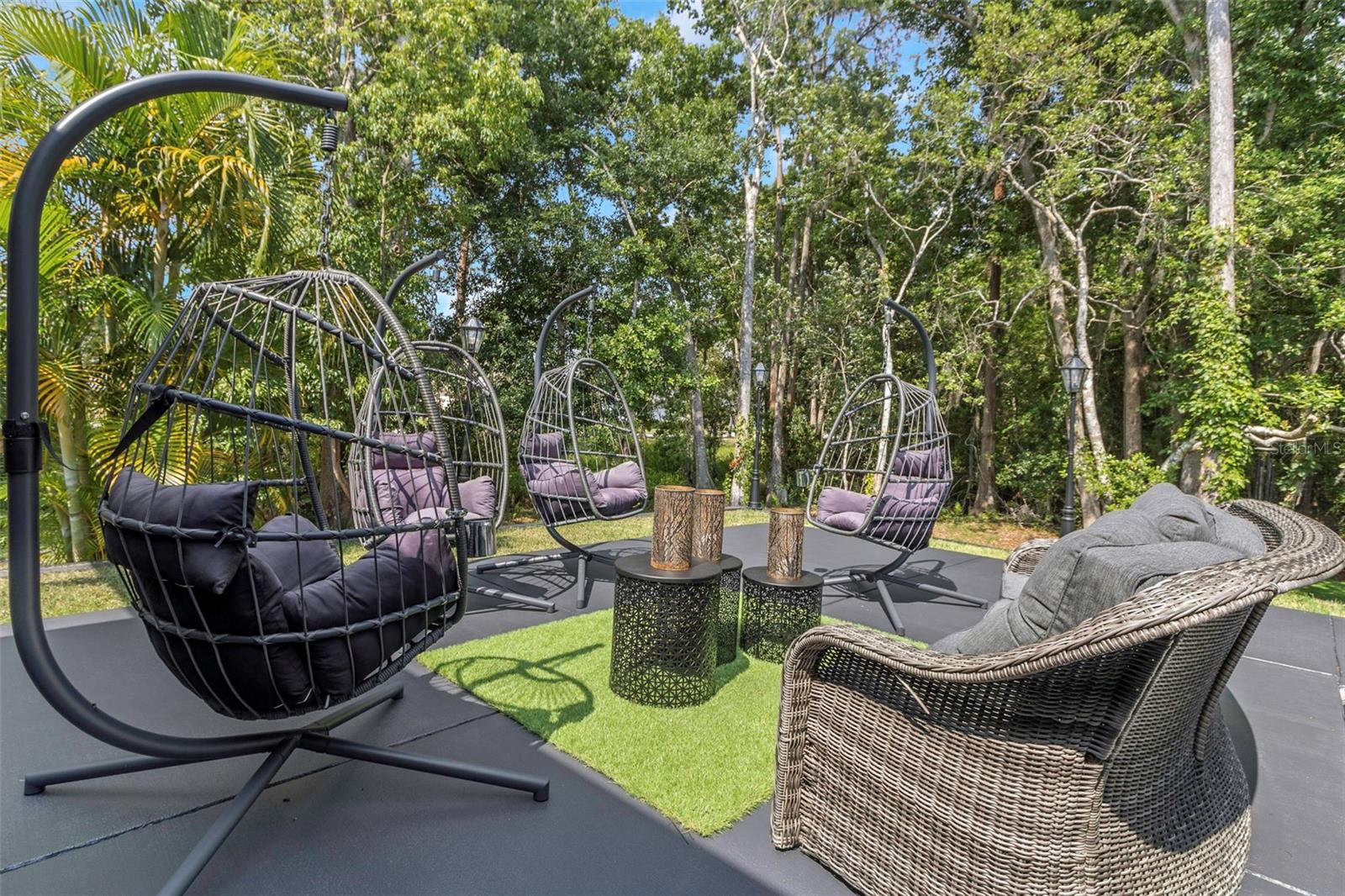 Patio with suspended swings to enjoy the mountain getaway feel overlooking the lush preserve that boarders this 3/4 acer parcel