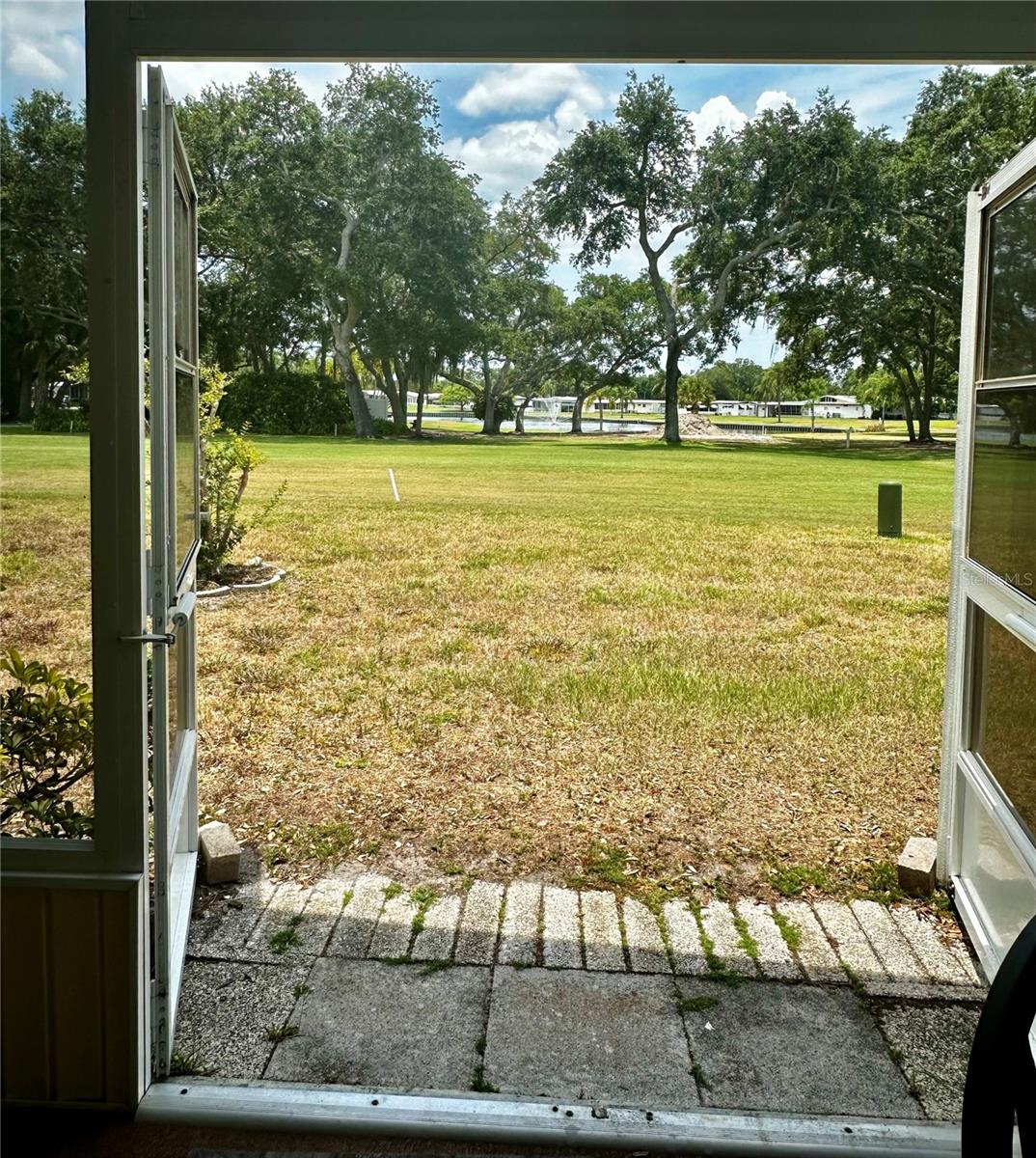 Double doors fully open to for golf cart storage and to enjoy the great outdoors.