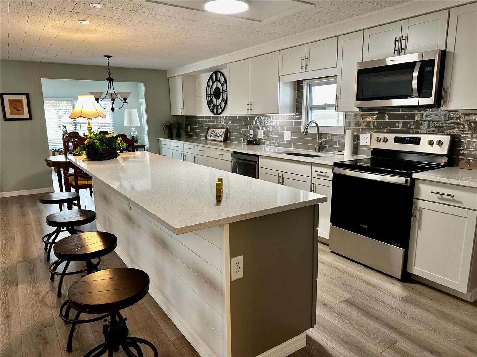 Massive island with Quartz counter top and barstool seating