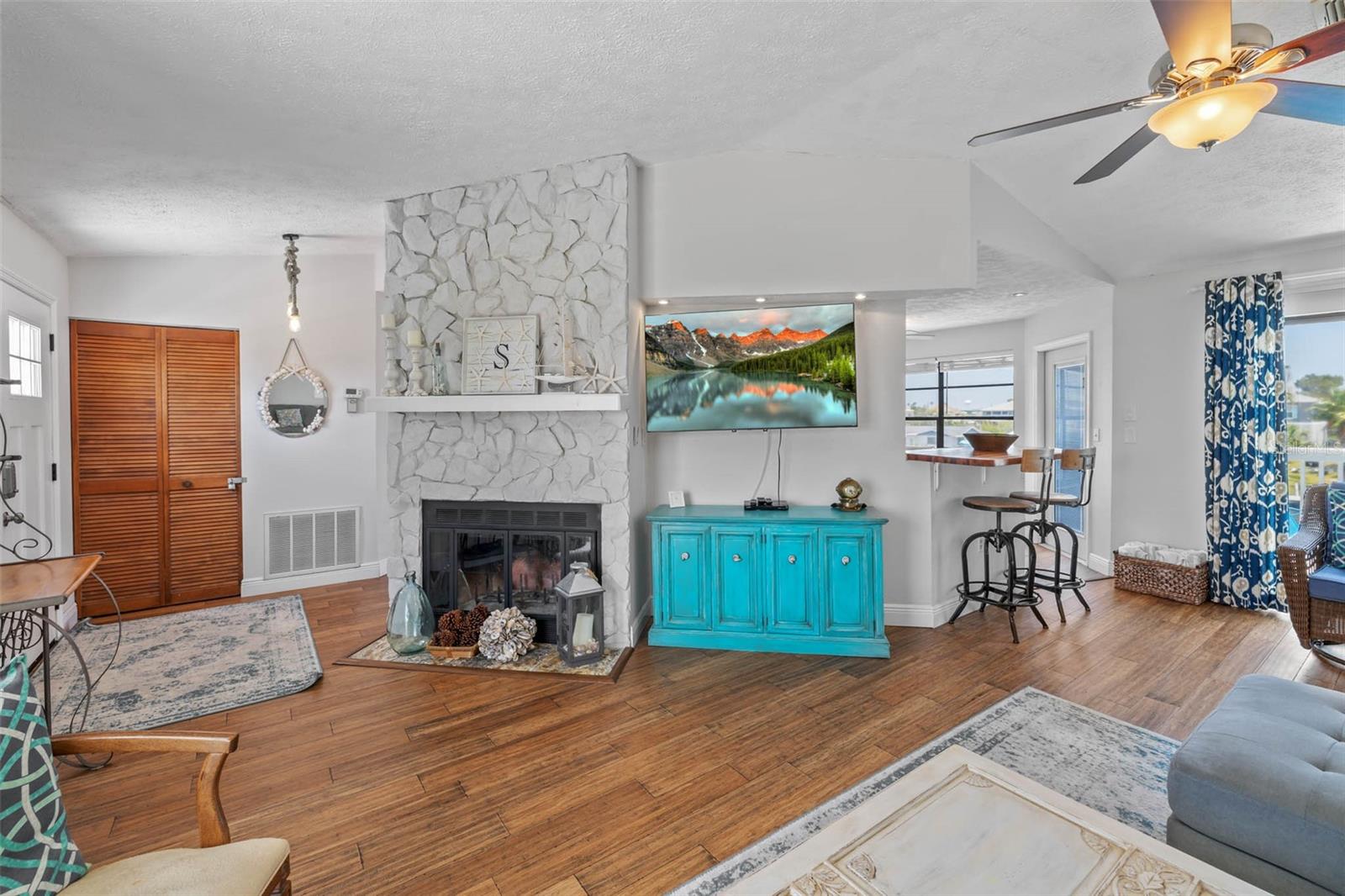 Living room with wood-burning fireplace.